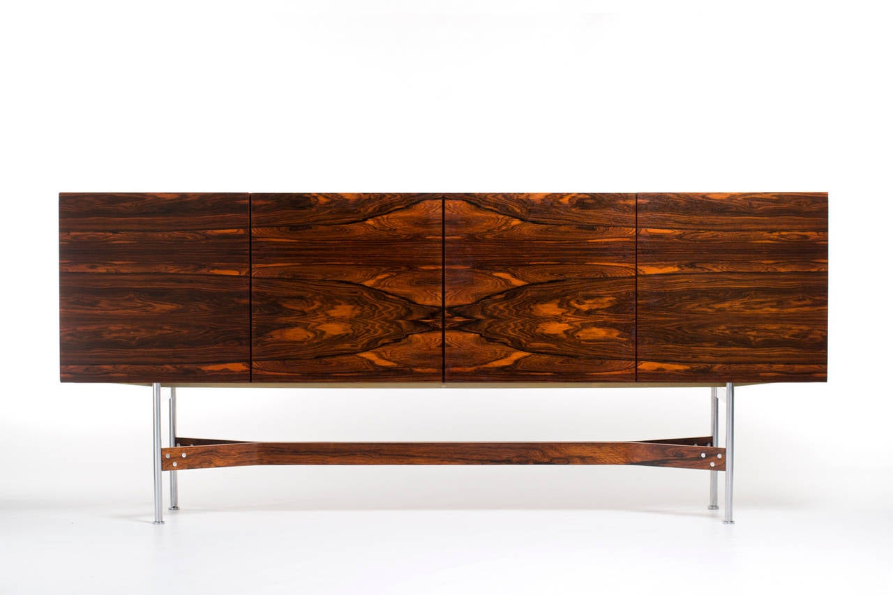 Stunning sideboard by Rudolf Bernd Glatzel for Fristho Franeker, Holland 1962. Made out of highest quality Rio Rosewood with a fantastic wood grain. Very nice sleek modern design with a beautiful organic base. The matt-chromed feet are connected by