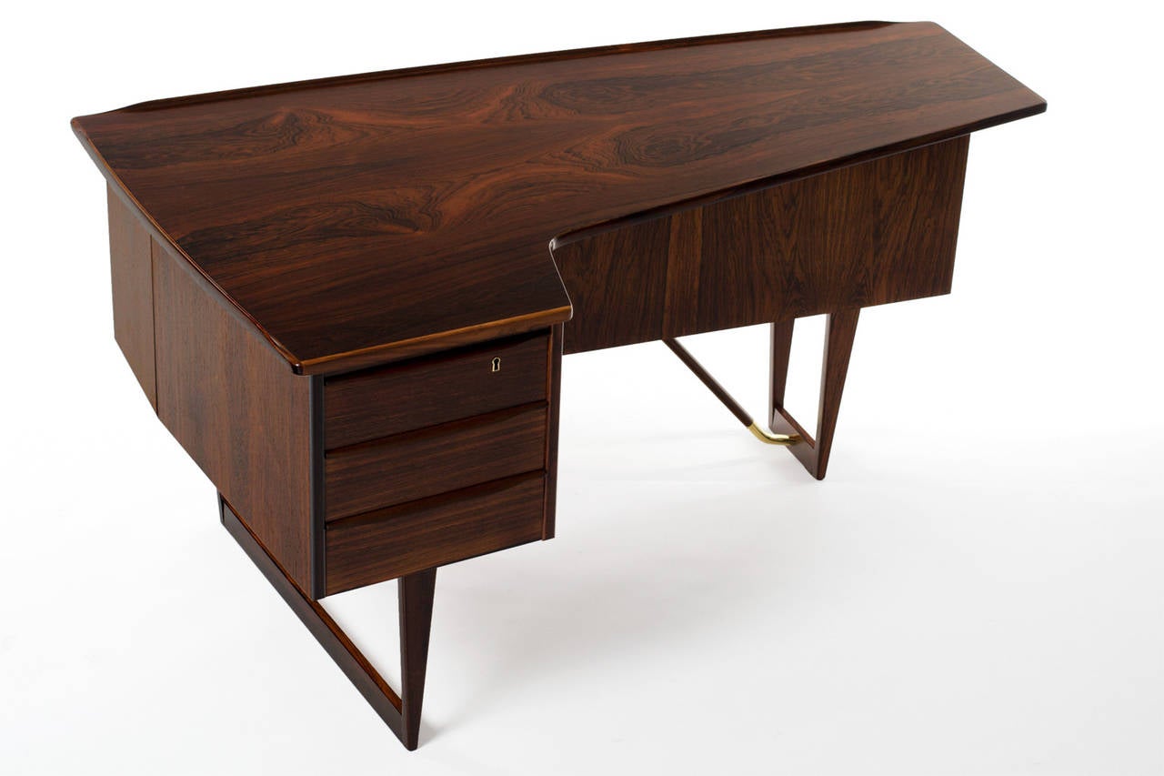 Rare desk by Peter Løvig Nielsen for Hedensted Møbelfabrik, Denmark 1956. Beautiful organic design made of Brazilian Rosewood. Looks great from every angle, with the bookshelf and a drinks cabinet at the front. Lots of nice details like the solid