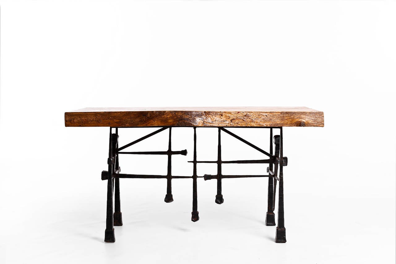 Impressive Brutalist side table, 1950's. Very heavy wrought iron base with a massive oak top. Beautiful artistic / sculptural piece in an excellent condition.