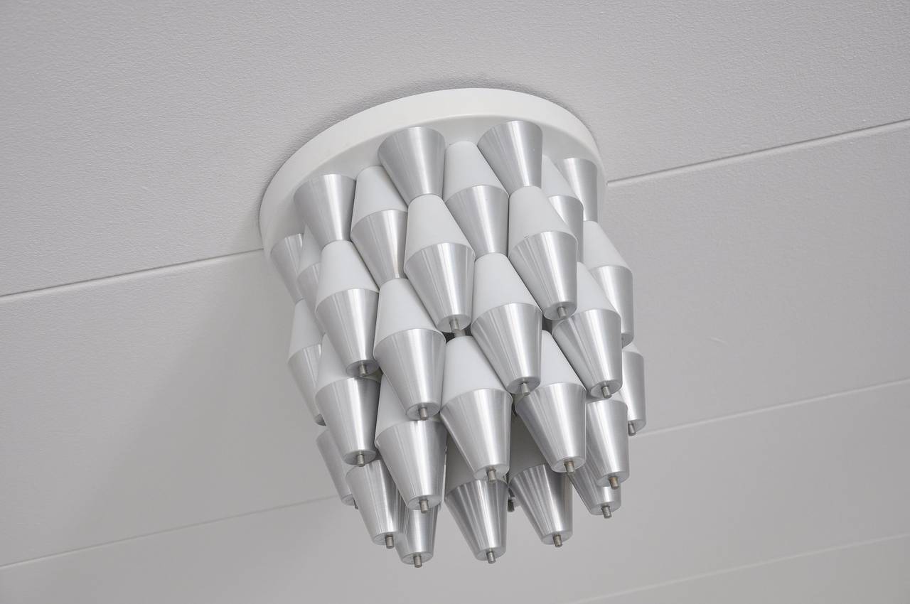 Very rare Ludiek ceiling lamp made by RAAK, Holland, 1960. This lamp shade was made of 50 aluminum and 50 plastic hoods that give a very nice light effect when lit. This lamp is one of the most spectacular lamps every made in Holland and very hard