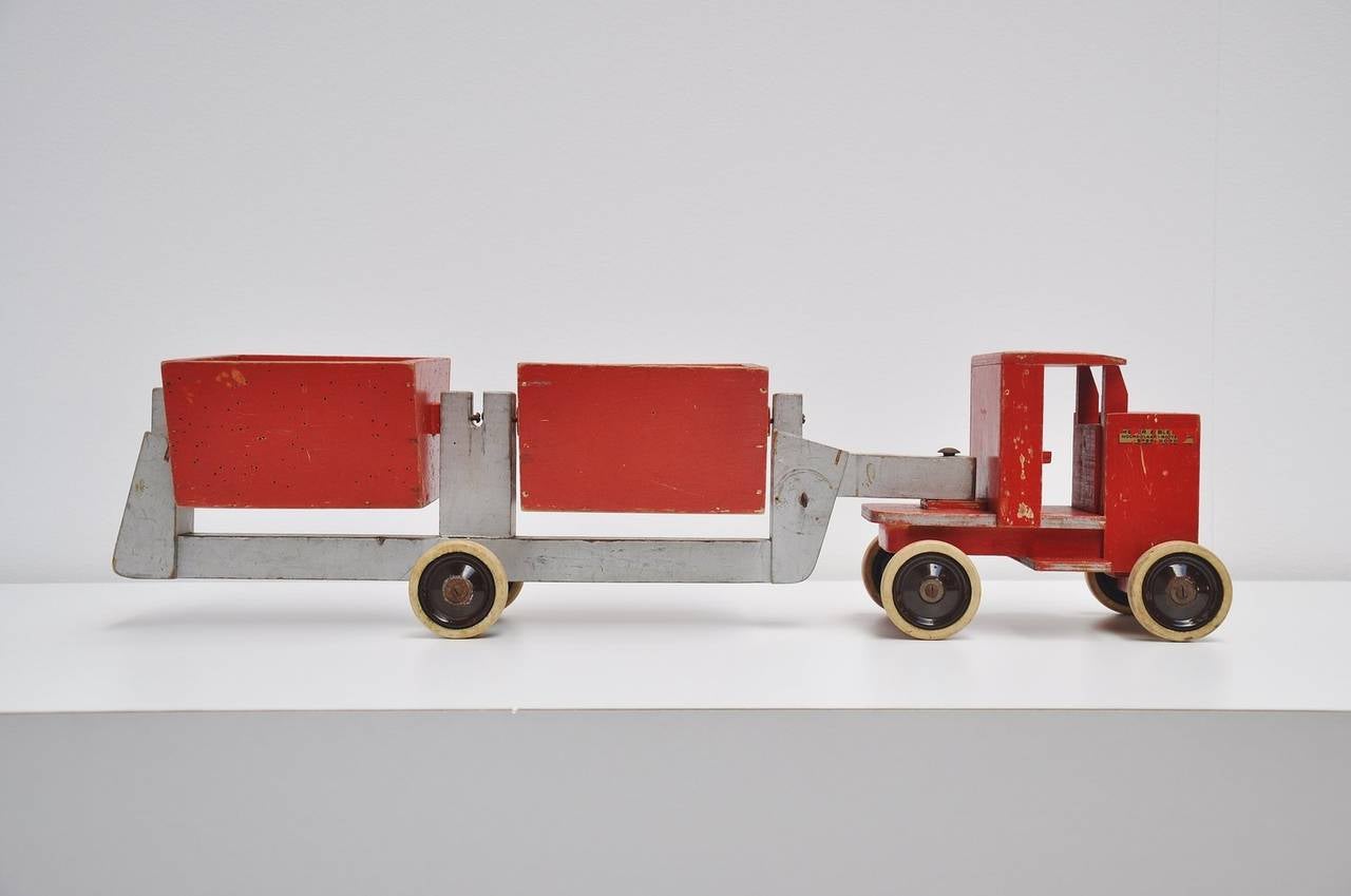Very rare toy truck model 965 made in 1939-1940 designed by Ko Verzuu for Ado Holland in 1939. ADO means Arbeid door onvolwaardigen, translated; labor by incapacitated, which makes this an even more special piece. Toys by ADO are being highly