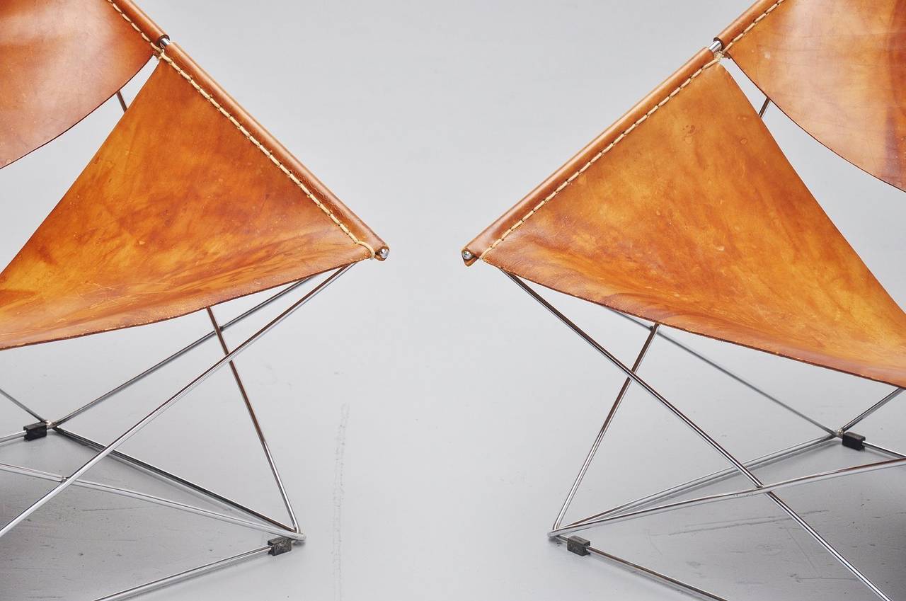 Extraordinary pair of Butterfly chairs designed by Pierre Paulin for Artifort 1963. Super shaped chairs, one of my Artifort favorites. Especially with this very nice and personal looking natural leather with an amazing patina. Superb patina to the