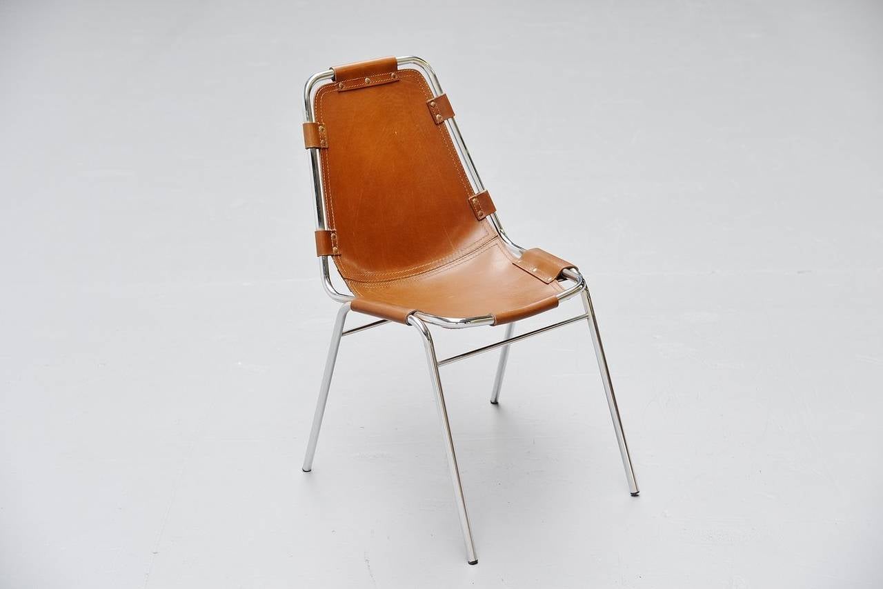 Nice side/dining chair by Charlotte Perriand for Ski resort Les Arcs in 1960. This is for a single brown leather chair in good original condition with wonderful patina to the leather. It has chrome tubular frame and high quality thick brown leather