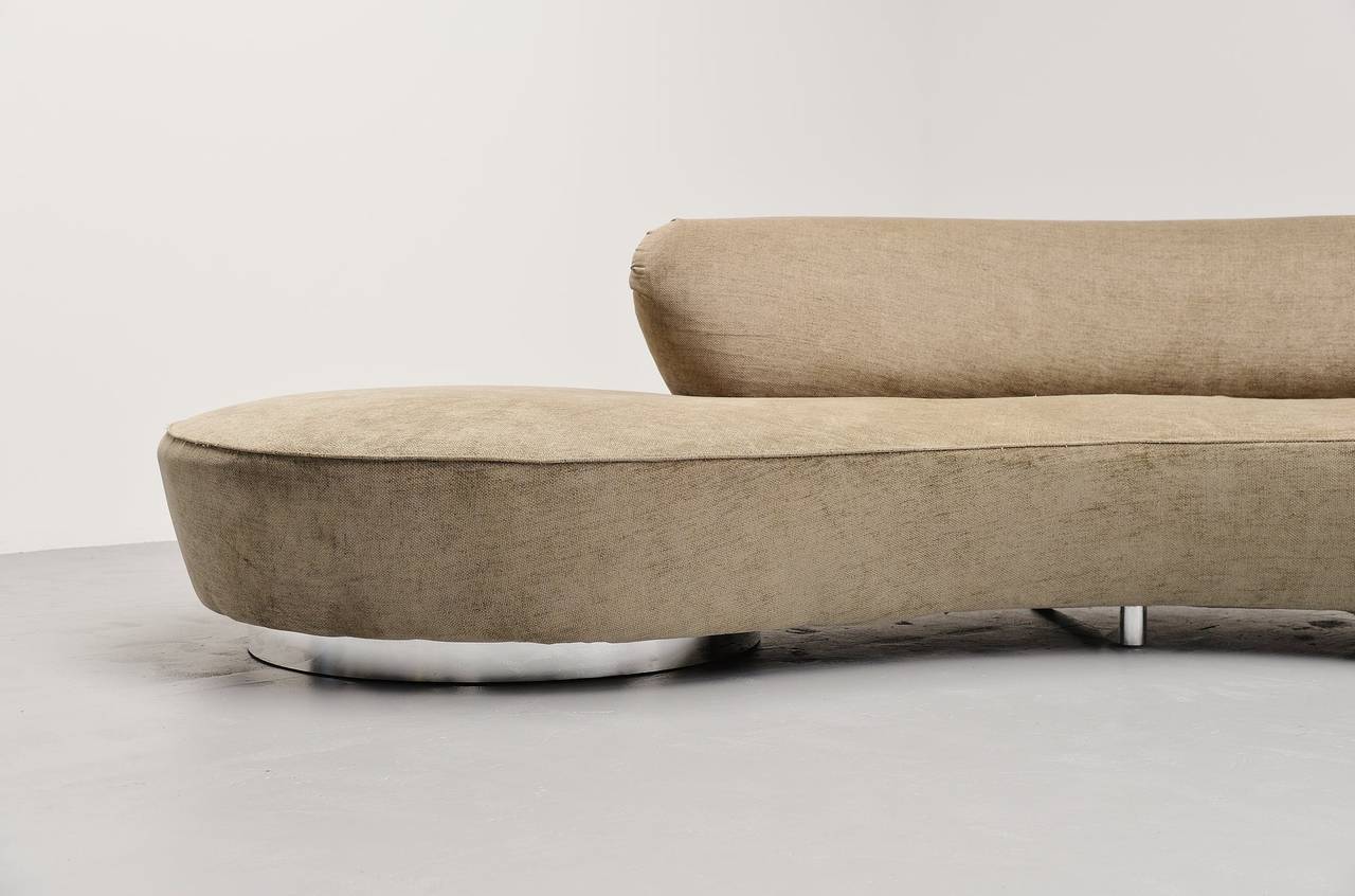 Amazing large lounge sofa designed by Vladimir Kagan. It is one of the most iconic designs by Kagan emphasizing the both sculptural organic form and user's comfort combined into 1 element. It features two round pedestals, chrome plated covers and a