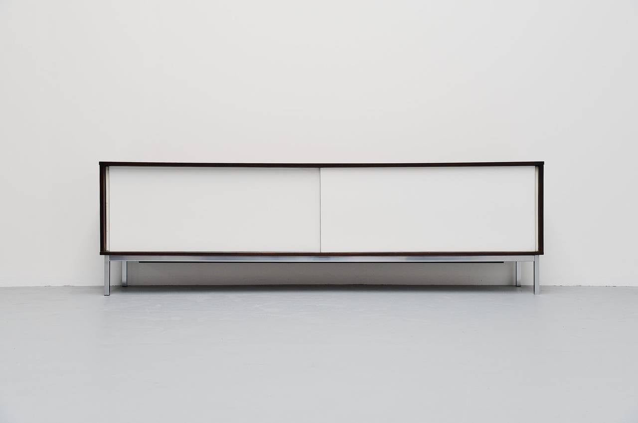 This is for a fantastic modernist sideboard designed by Martin Visser for ‘t Spectrum Bergeijk, produced between 1965 and 1971. This is the longest version of this sideboard at 236,5 cm. The sideboard is in wenge wood and has white laminated doors,