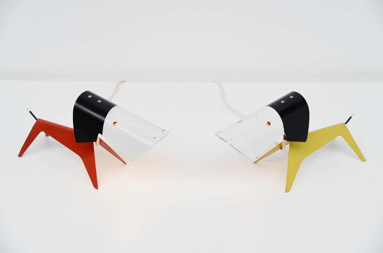 Ultra rare pair of dog shaped lamps designed by Jean Boris Lacroix for Disderot, France, 1950. This is for a super cool pair of lamps in red and lime green. Both lamps are in exceptional original condition with normal wear from age and usage but