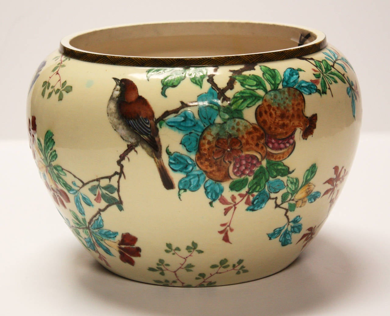 Antique hand decorated jardinière by artist Theodore Deck. Oriental influence with images of birds, butterflies and flowers executed in brilliantly colored enamel.