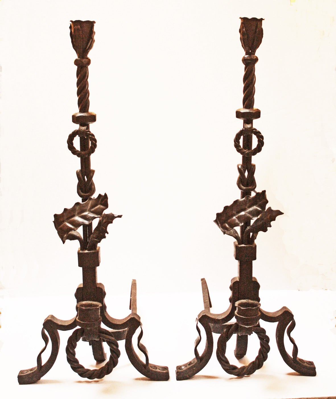 Beautifully articulated andirons with thick twisted detail and thistle leaf motif.