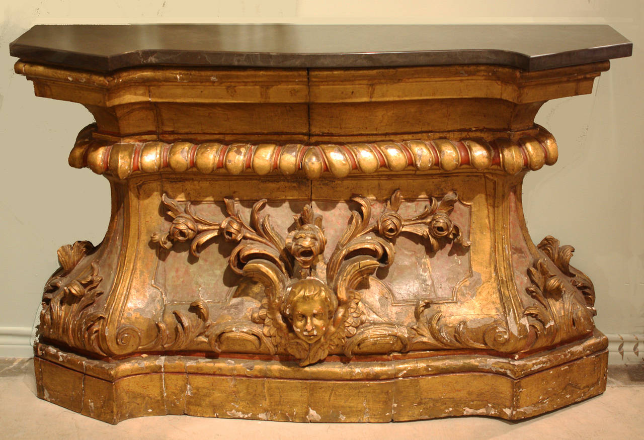 19th century wood console carved in high relief with gilt gesso surface and new Belgian black marble top.