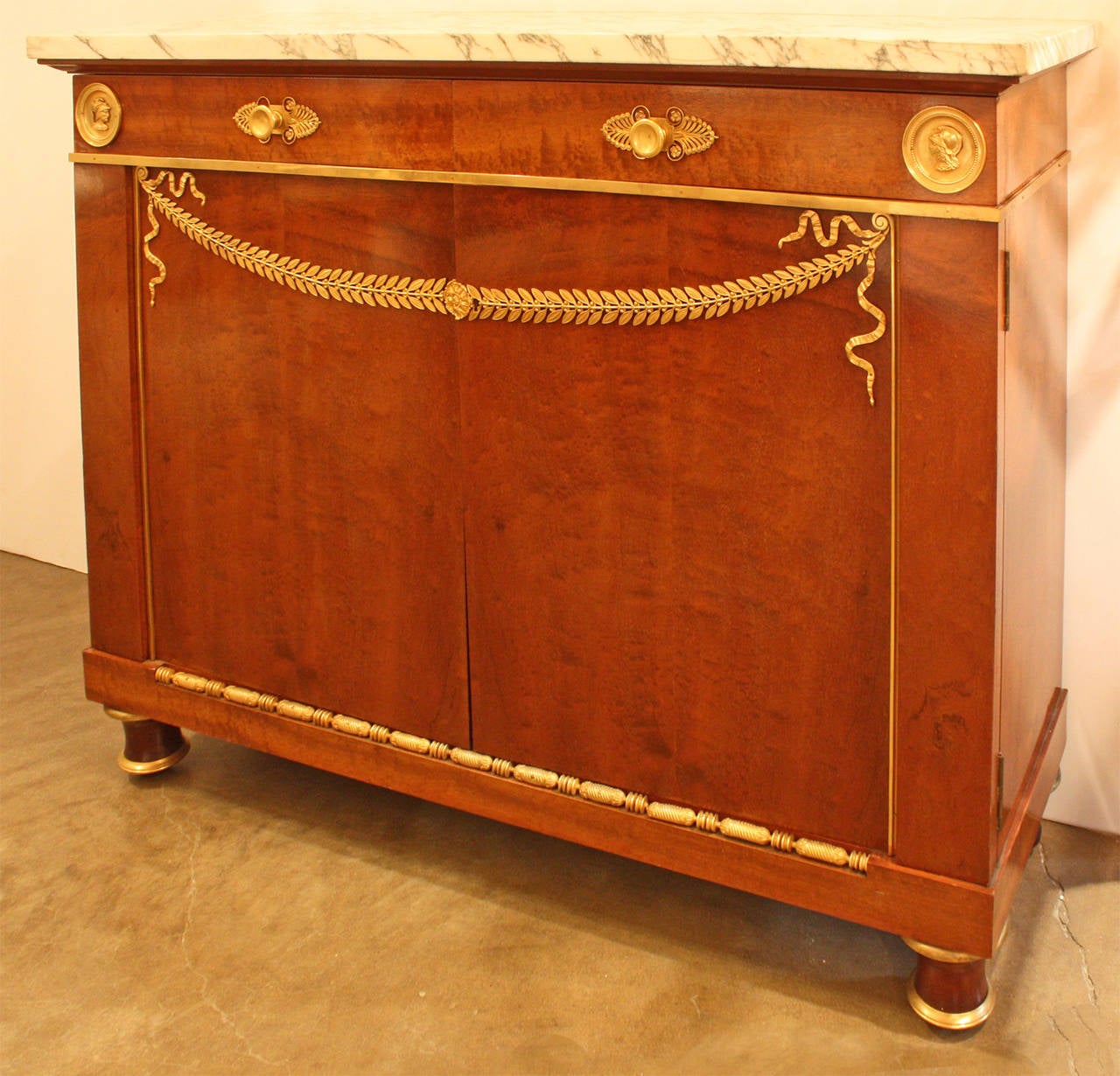 Neoclassical buffet from the designer, Feres Mercier, a distinguished French furniture manufacturer founded in the late 19th century in Paris on Rue Faubourg Saint-Antoine. Buffet has marble top and is adorned with bronze gilt decor.