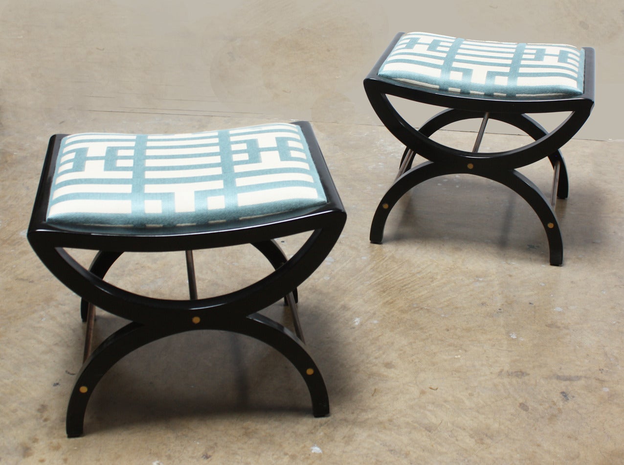 Edward Wormley for Dunbar pair of ottomans, circa 1960. Newly restored black lacquer finish with brass stretchers and upholstered seat.