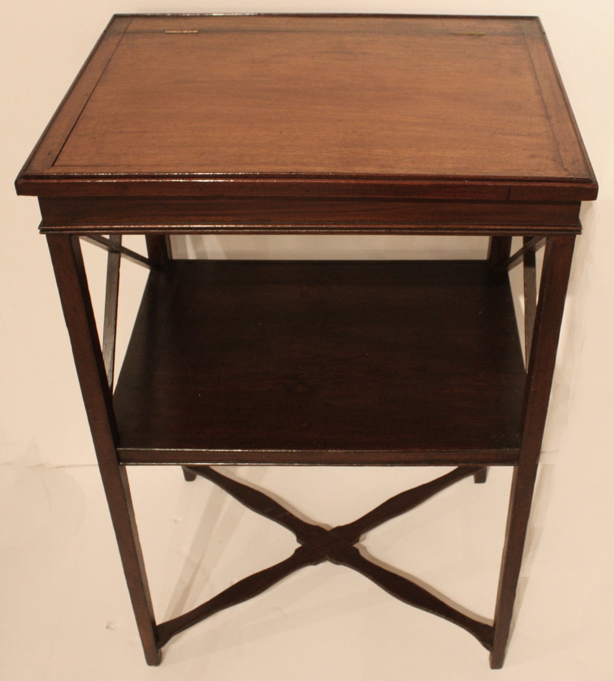 Important antique American standing desk crafted in mahogany and pine. The mahogany writing surface retains its original patina and lifts to reveal a storage compartment. Underneath the desk is the original hand-forged iron 