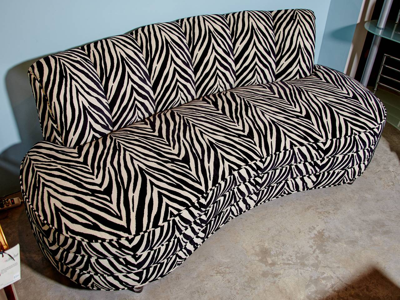 A pair of Ketcham & Rothschild, Chicago, Illinois, sofas now upholstered with designer zebra upholstery and fitted with custom designed acrylic legs.  Ketcham & Rothschild was an American manufacturer of premier quality upholstered furniture from