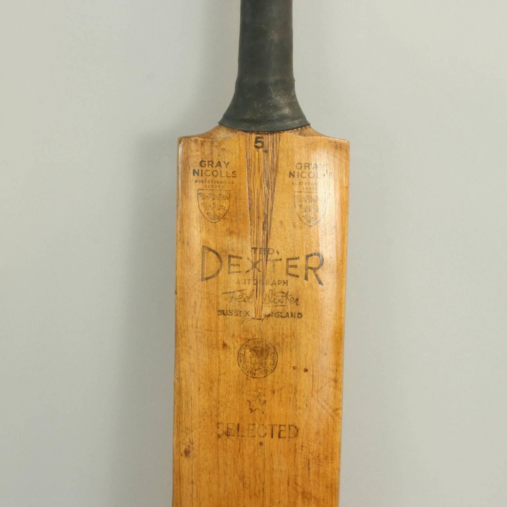 A good willow cricket bat stamped on the face with a facsimile autograph of Ted Dexter with the Gray Nicolls trade mark shield. A nice clean bat with a rubber grip but the blade does have a crack in the front. 
 
Edward Ralph Dexter CBE, known as