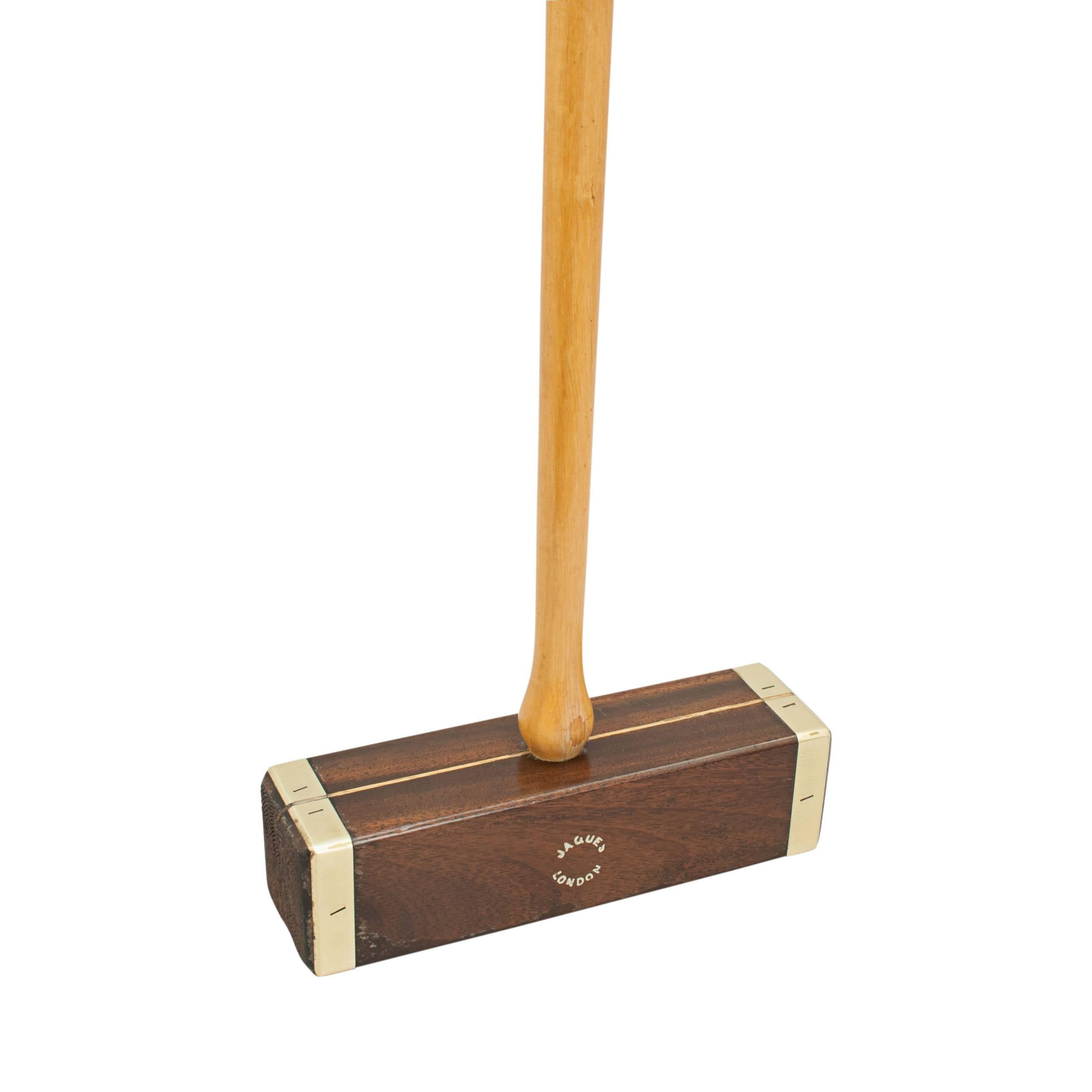 Vintage brass bound Jaques Croquet mallet. 
A singular brass bound, square head, croquet mallet made by John Jaques. The mallet head is made from hardwood with circular face markings, an inlaid alignment guide and an octagonal hickory handle. The