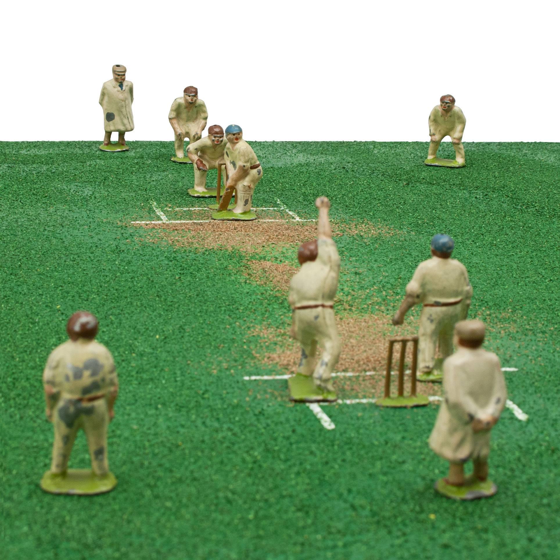 Lead Cricket Toy Figures. 
An unusual and very rare set of lead toy figures of cricket players. The figures have been set out as a cricket match and comprise of two Batsmen, two Umpires, Bowler, Wicketkeeper, three Slips, six Outfielders and two