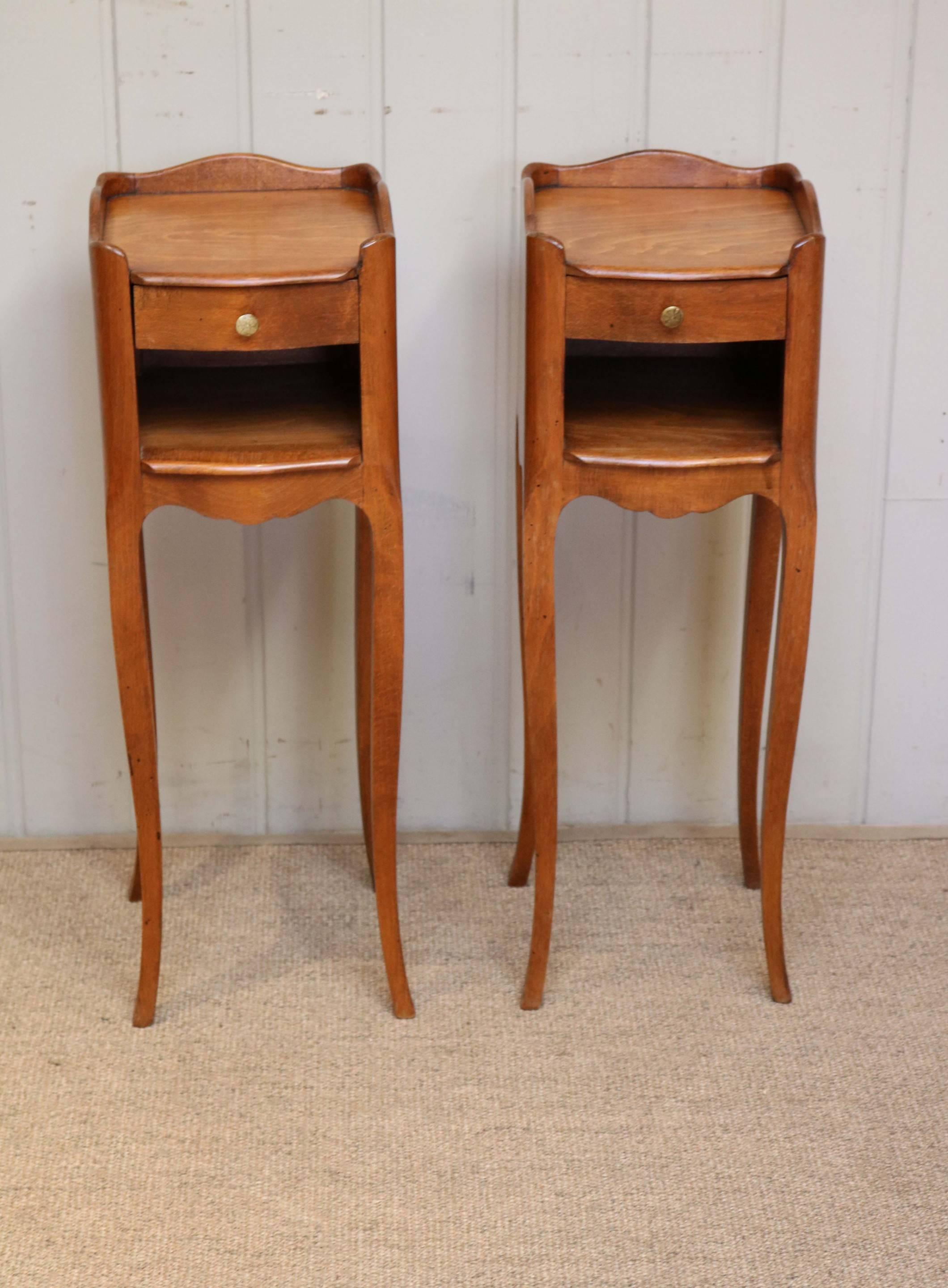 Pair of small proportioned cherrywood bedside cabinets with a single drawer above an open cupboard base raised on cabriole legs.