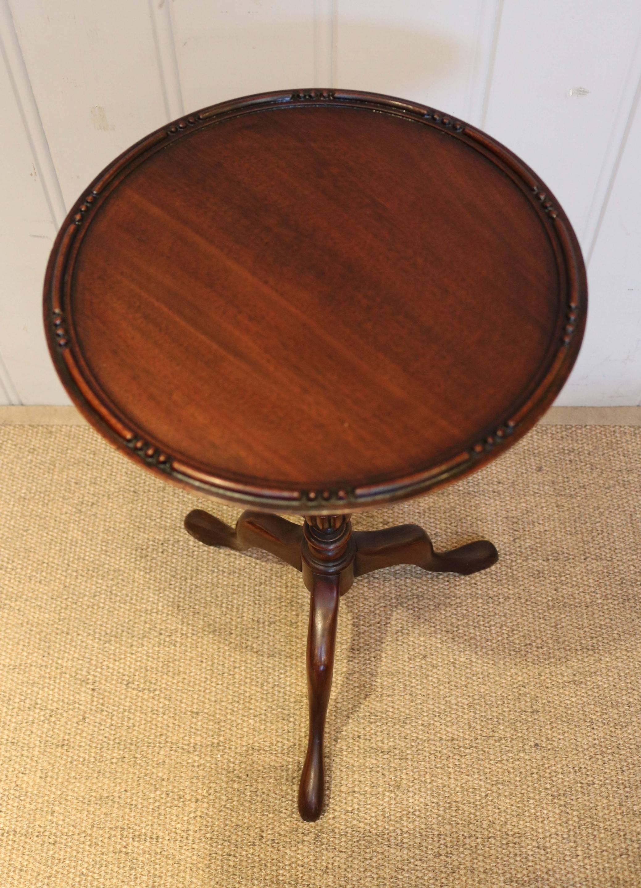 Matched pair of mahogany wine tables having a turned tripod base with fluted carving. One of the tables is slightly smaller at 52 cm high.