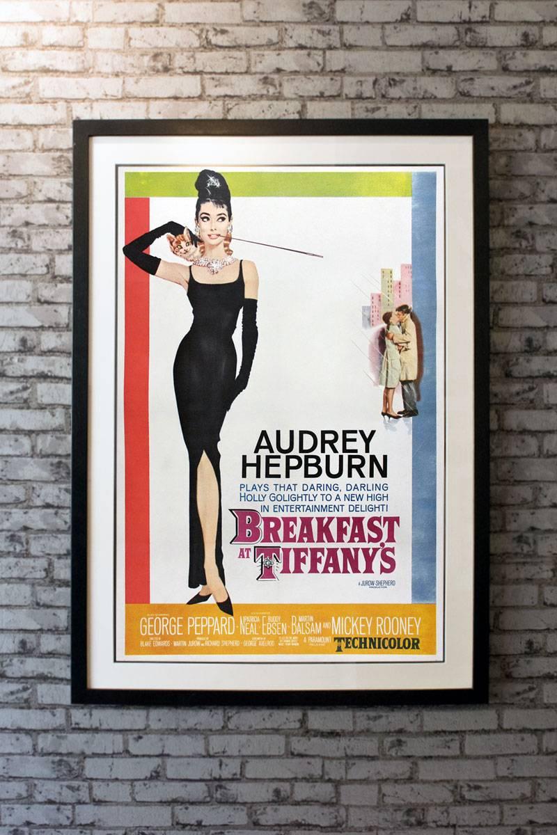 A monumental one sheet from an equally magnificent film. This rare US poster has the iconic artwork for Audrey Hepburn’s most popular film! Skilfully adapted from the Truman Capote novella, this darling movie had it all with, romance, humour, New