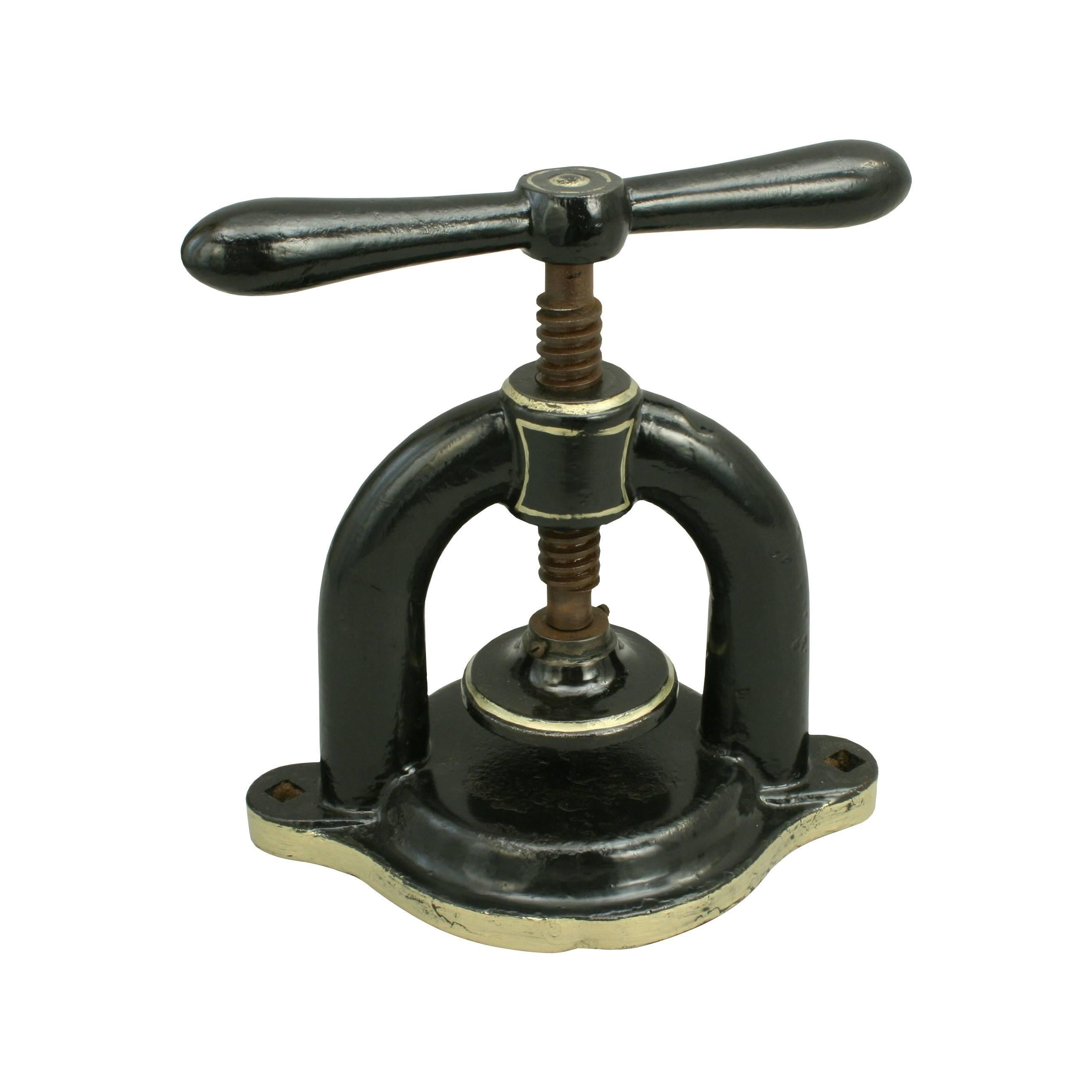 A heavy duty cast iron gutty golf ball press for early golf ball moulds. The tap handled screw down press is horse shoe shaped and is for mounting onto a work bench. To make a gutty golf ball first the gutta-percha was heated and loosely rolled into