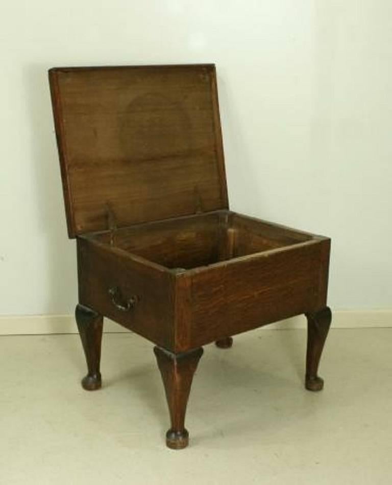A 19th century oak commode with hinged lid, with four cabriolet legs. The original interior has been replaced with a solid shelf. It has two carry handles on the sides. A fine and useful bedside table or coffee table.