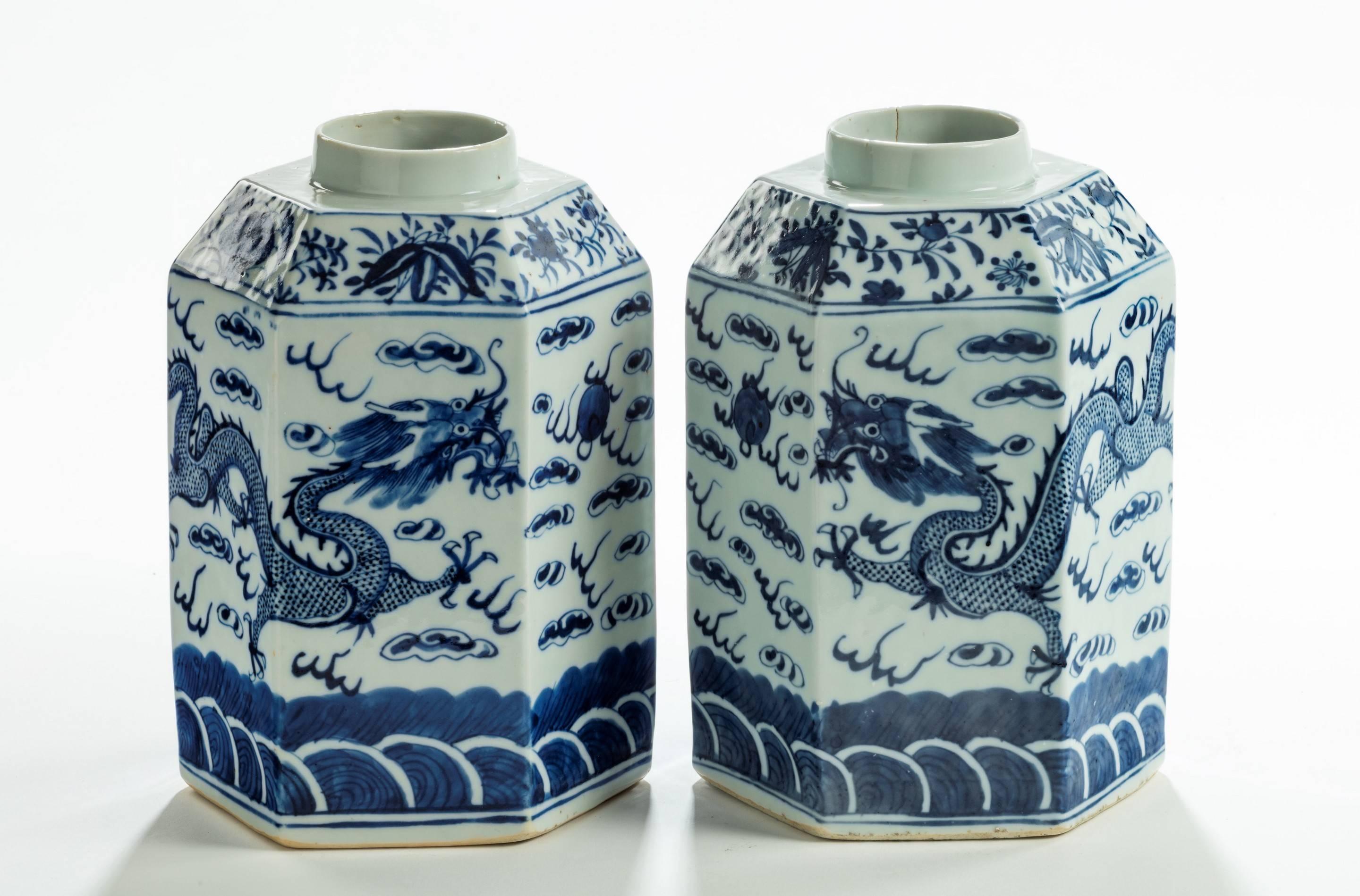 A pair of 19th century blue and white Chinese hexagonal shaped tea jars. Late 19th century. Two dragons amongst the clouds over the sea or mountains? Now ideal for converting into lamps.