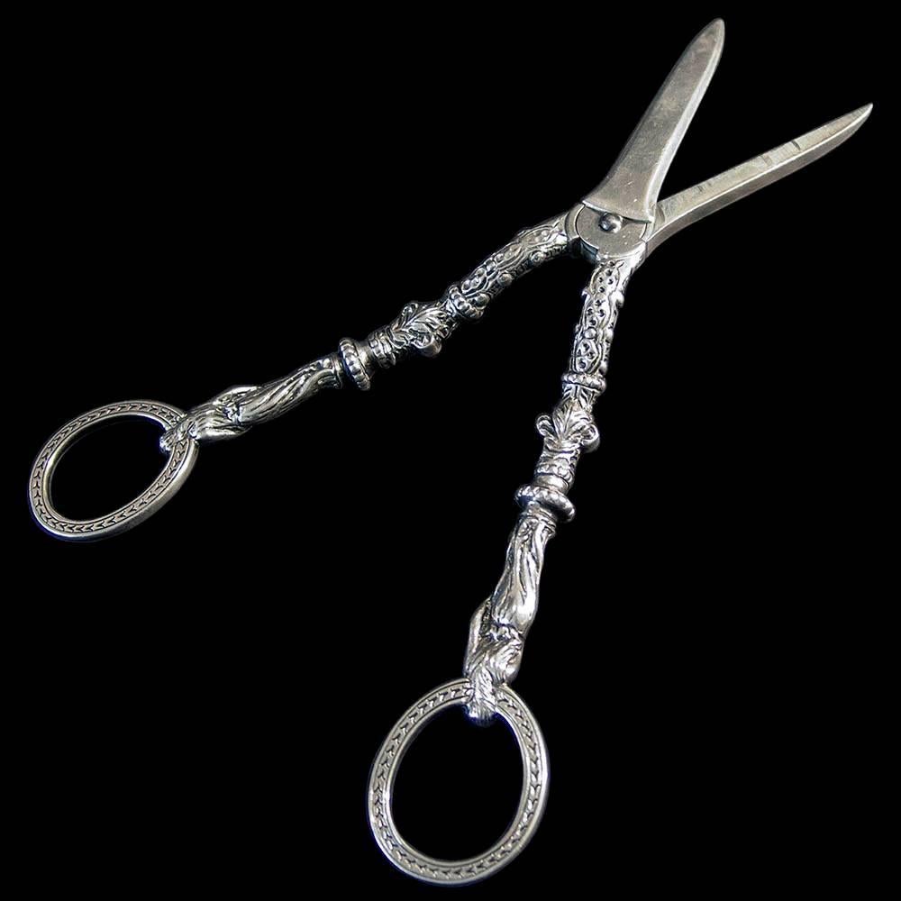 A fine pair of decorative silver grape shears the engraved finger rings mounted on classical female figures. Each arm hallmarked on the internal face of the cutting blade.