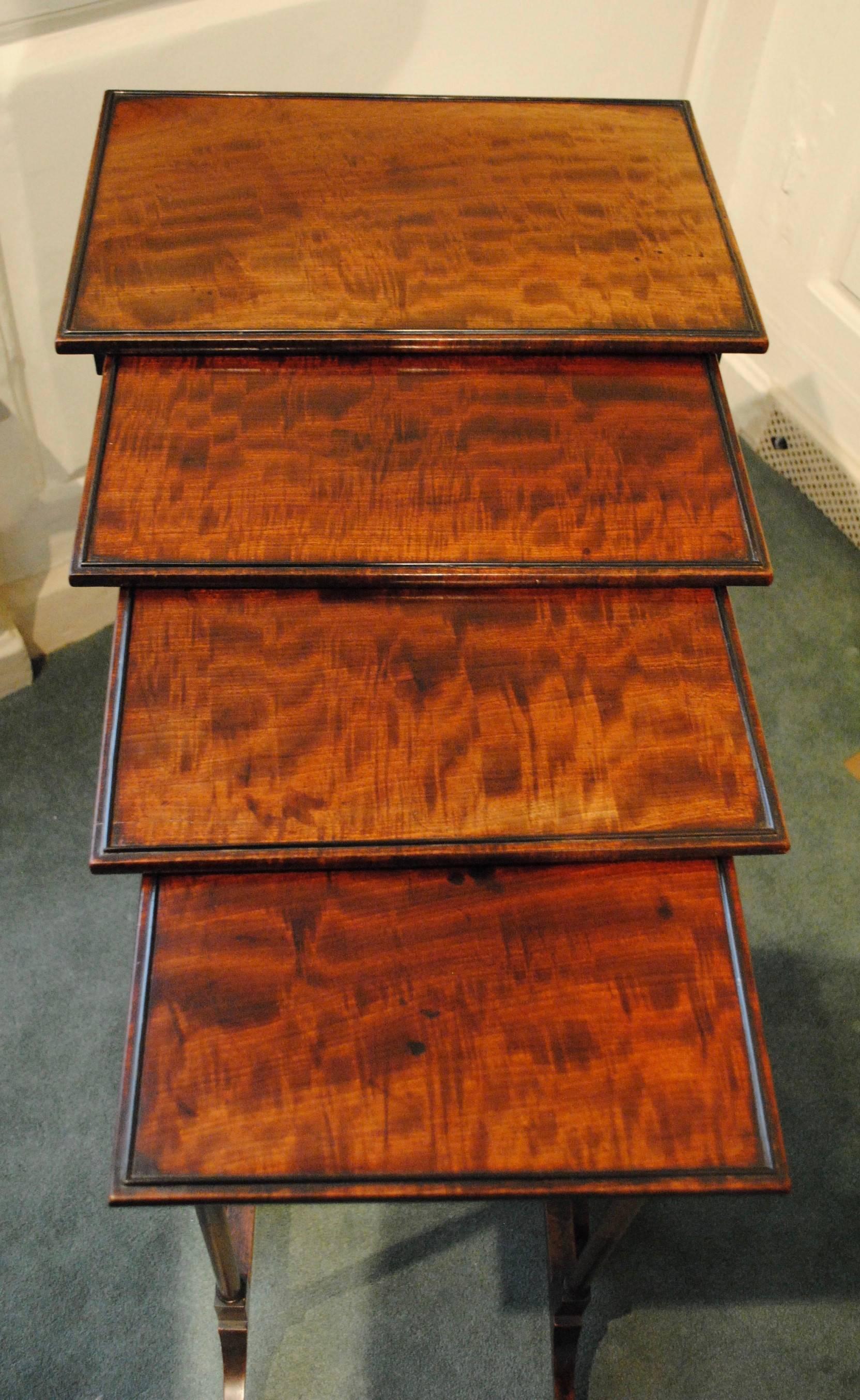 A fine quality nest of four late 18th century tables in superb original condition the tops with well grained fiddle back mahogany and ebony beading.