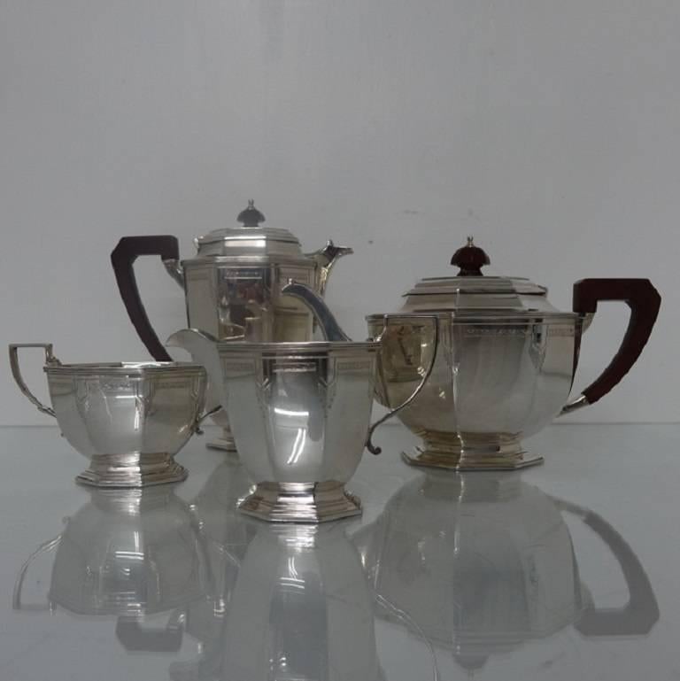 A highly collectable silver four piece Art Deco tea set, octagonal in design with elegant hand engraving for highlights on the body. The lids of the tea and coffee pot are hinged and the handles are scroll form in design. 

Height: 

Coffee pot:
