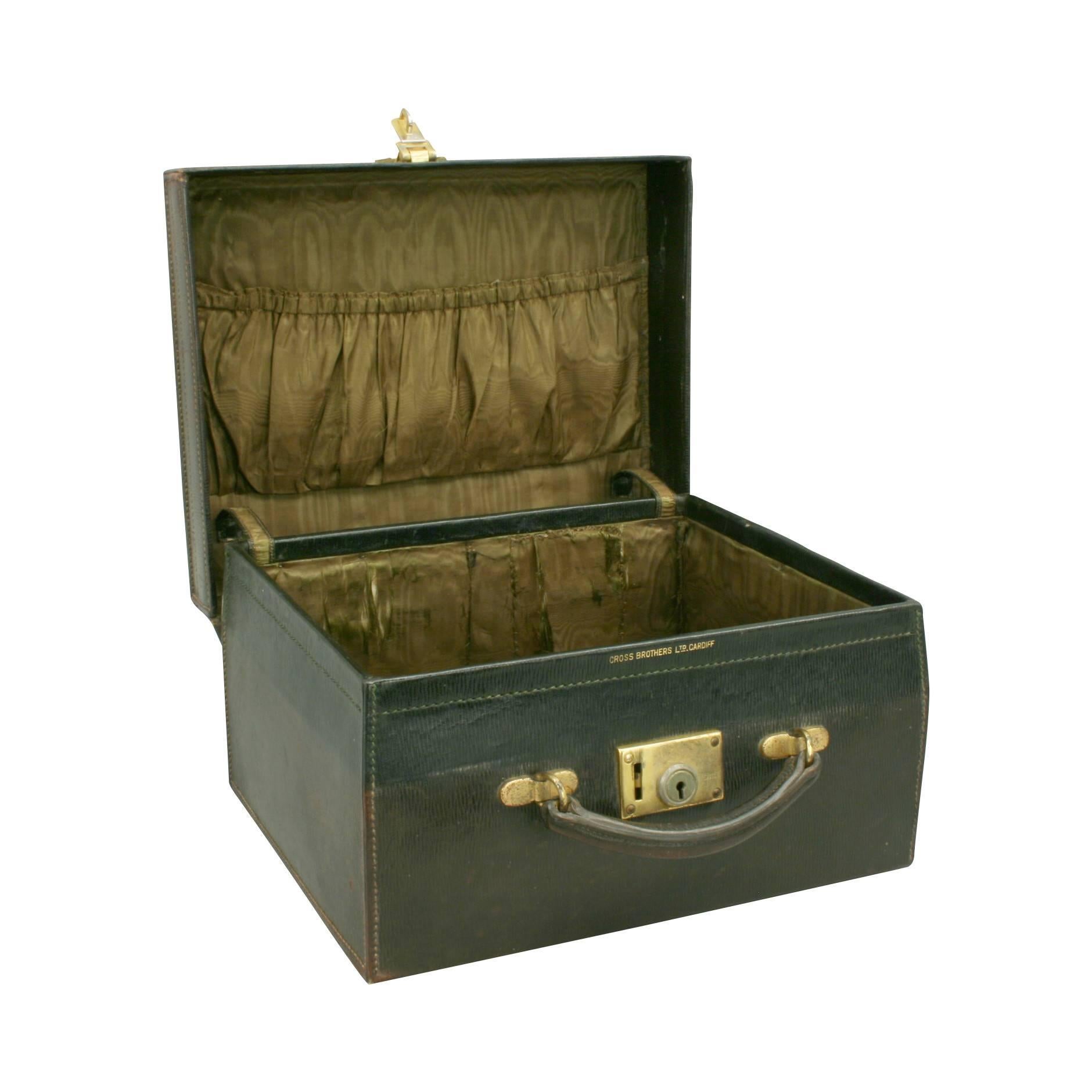 A 1920s green Morocco leather travelling case by Cross Brothers Ltd., Cardiff. The interior lined with original silk lining (slight damage) the lid with elasticated pocket. Exterior leather in very good condition with single carry handle and the top