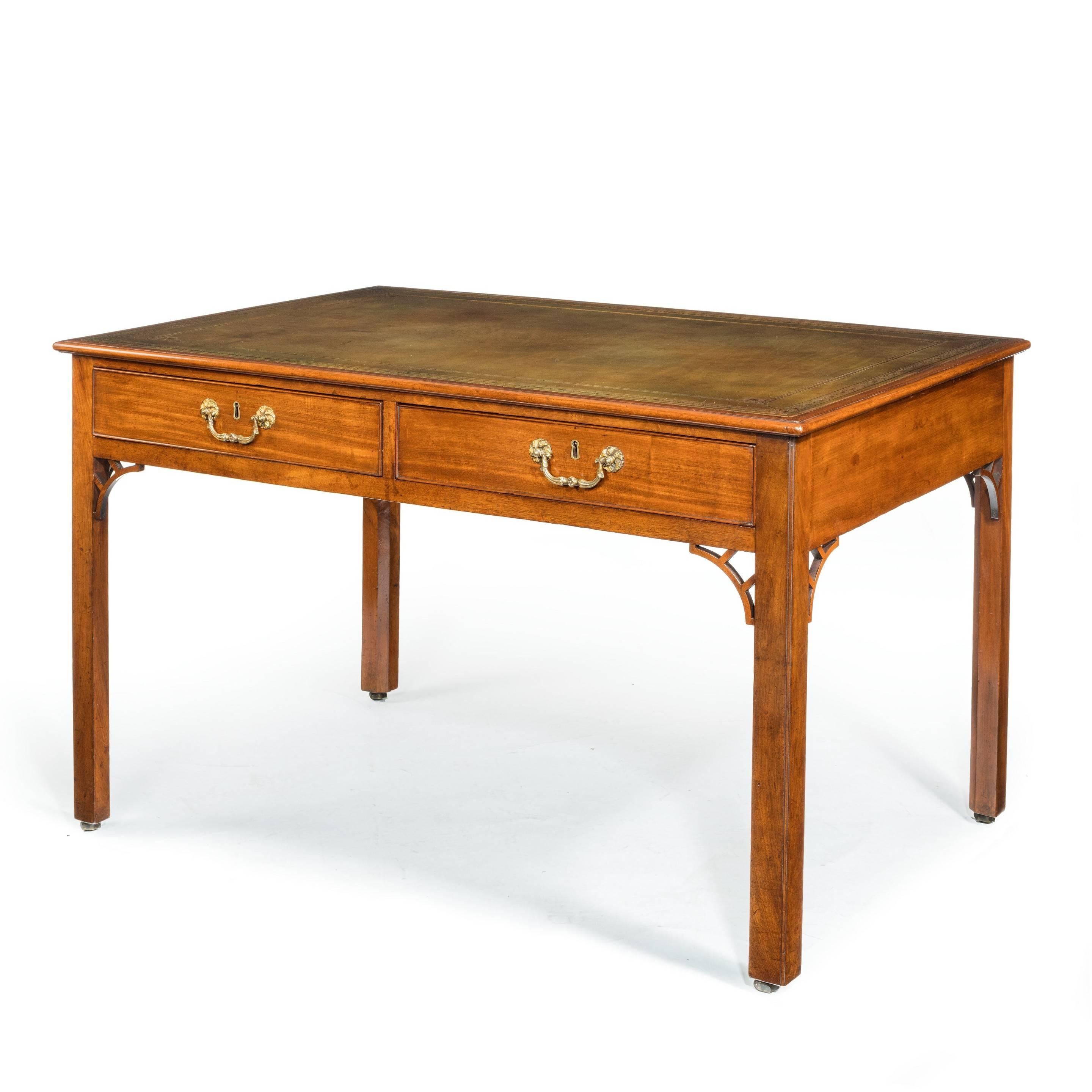 A Victorian mahogany four drawer writing table, 
The rectangular leather inset top set on four square-section legs with open works spandrels, with two drawers on each side.