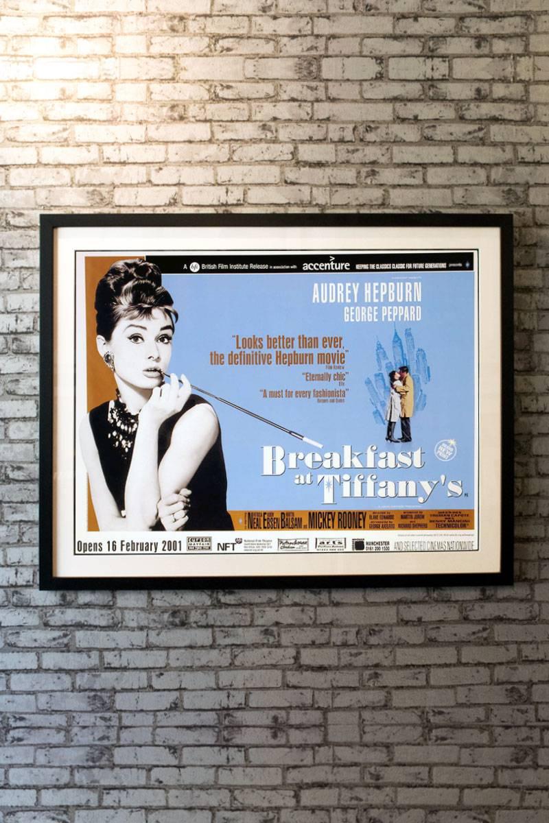 A treasure to behold, this large format poster shares similar artwork with the one sheet, but is a much rarer format. Audrey Hepburn dons the iconic Givenchy black gown, sizable pearl necklace, and twinkling diamond hair jewelry, a look that has