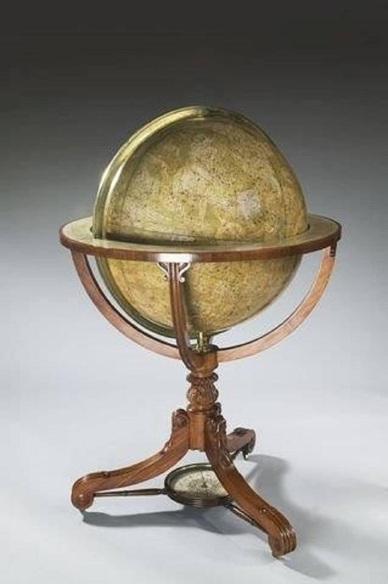 These 24 inch globes are set in George IV mahogany stands with acanthus knops above three scrolling legs joined by slender turned stretchers centred on later compass roses. The terrestrial gores are updated with maps from 1852 and the celestial ones