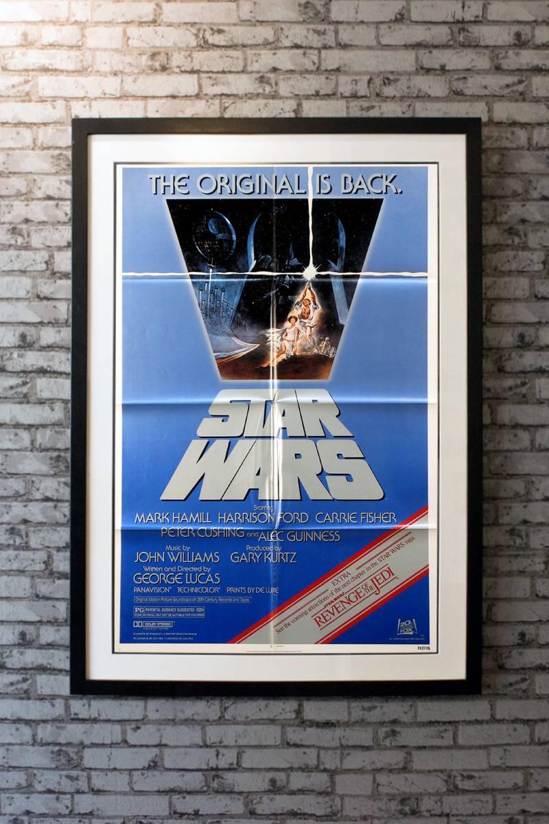 Starring Mark Hamill, Harrison Ford, Carrie Fisher, Alec Guinness, Peter Cushing, Anthony Daniels, Kenny Baker, Peter Mayhew, David Prowse and James Earl Jones. Directed by George Lucas. Artwork by Tom Jung.

Linen-backing + £150

Framing