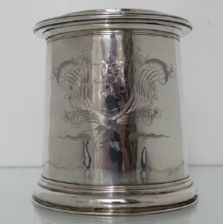 A very rare example of a highly collectable 17th century tankard. The tankard is cylindrical in design with upper and lower bands of reed engraving for decoration on the body. The center of the body has a elegant contemporary armorial for