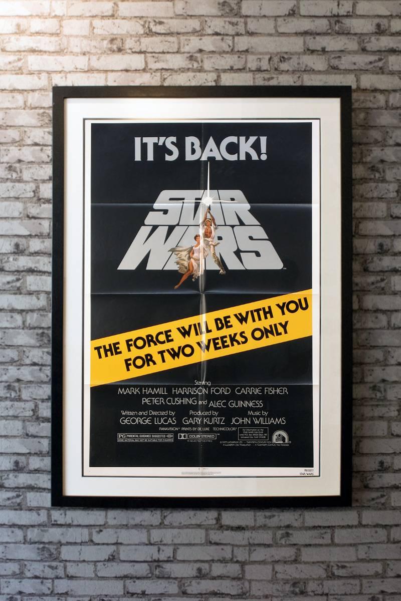 Starring Mark Hamill, Harrison Ford, Carrie Fisher, Alec Guinness, Peter Cushing, Anthony Daniels, Kenny Baker, Peter Mayhew, David Prowse and James Earl Jones. Directed by George Lucas. Artwork by Tom Jung. 

Linen-backing + £150

Framing