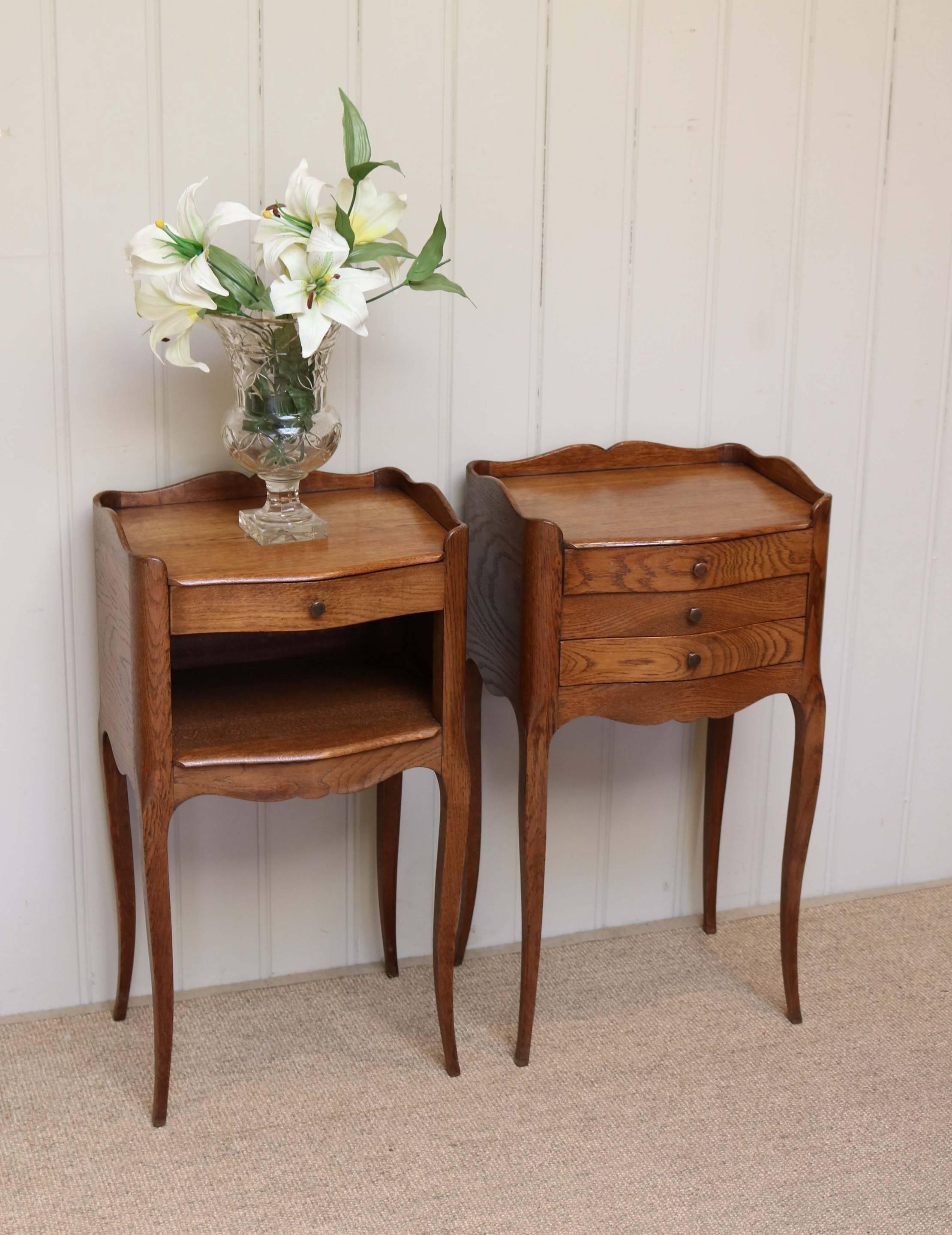 Pair of French oak bedside cabinets having three drawers to one and the other with a single drawer above an open cupboard base with a shaped apron and cabriole legs.