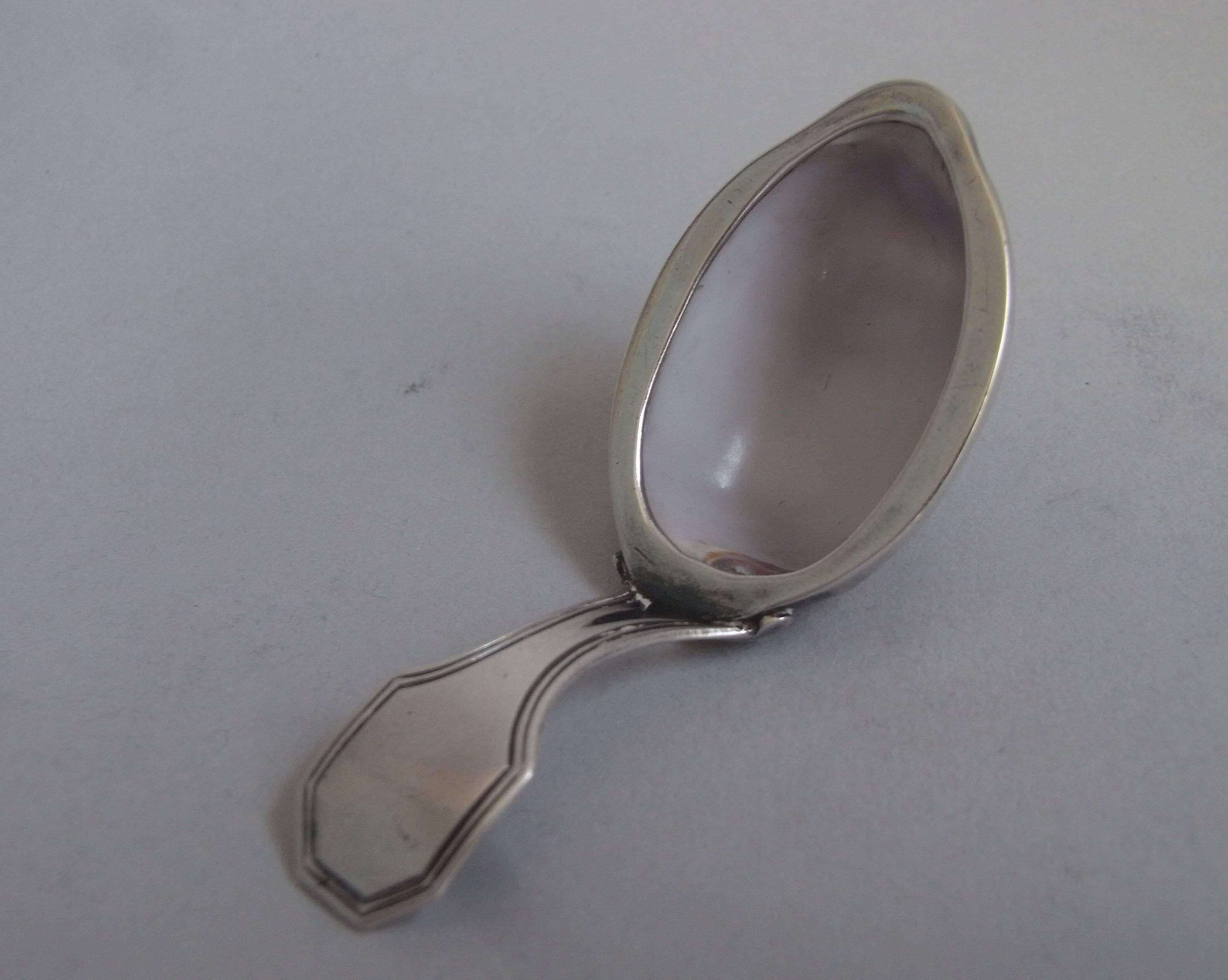 The bowl of the Caddy Spoon is formed as a beautifully shaded natural Cowrie Shell. The shell bowl has a plain silver rim and the bifurated handle displays a double thread edge. This example is in excellent condition and is marked with the maker's