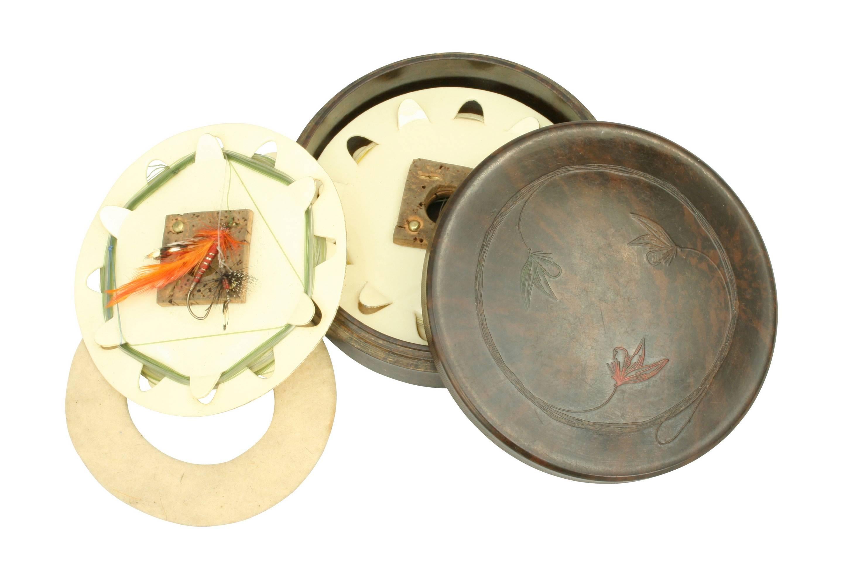Hardy Neroda fly fishing cast box.
A round original Hardy Neroda fishing cast box made from Bakelite. The screw on lid is decorated with embossed flies on leaders. Hardy Bros made in England is stamped on the rear. The box contains two ivory white