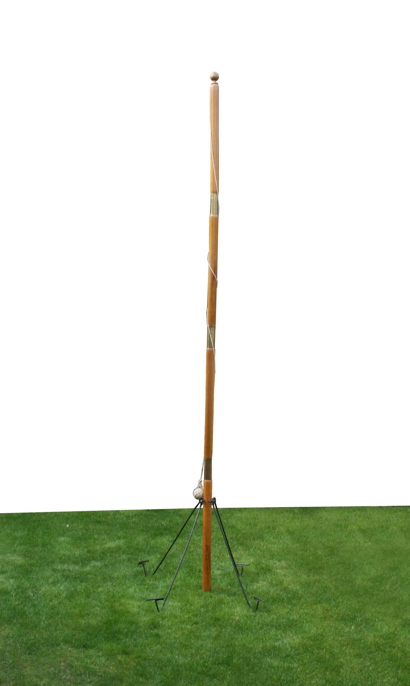 A late Victorian or early Edwardian Tetherball or Swing ball tennis game. The game comprises of a large beechwood pole, metal pegs and ball in original refurbished pine box. The pole is in four sections with metal securing struts for fixing to the