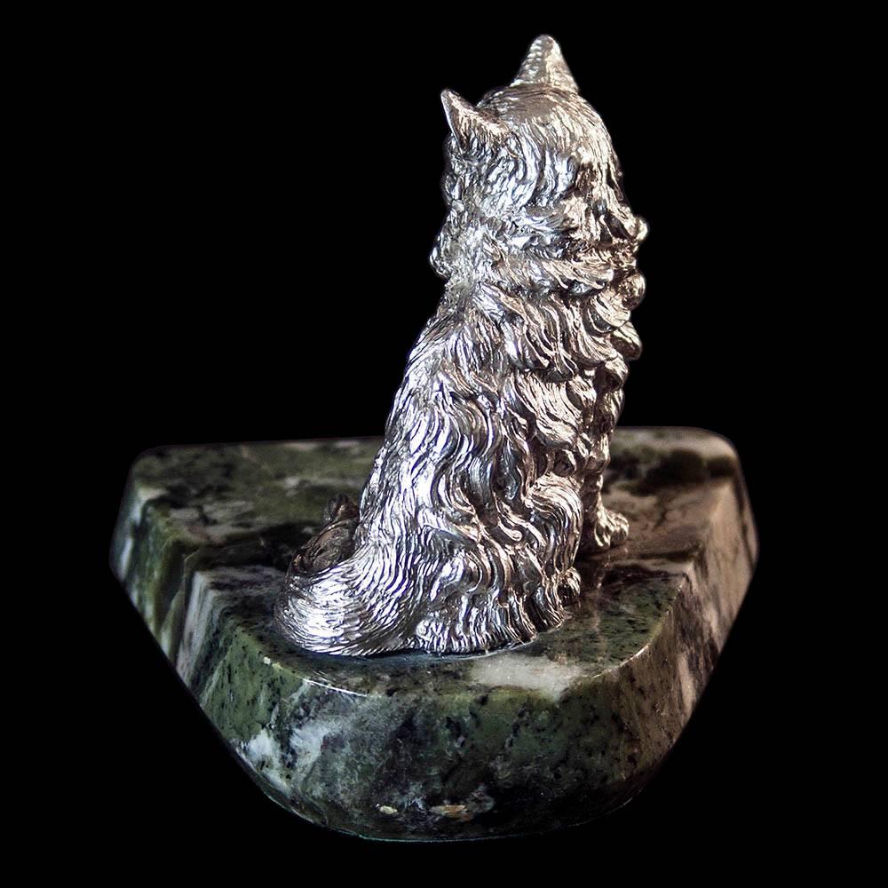 A nicely modelled silver cat sitting on a green hard-stone base.