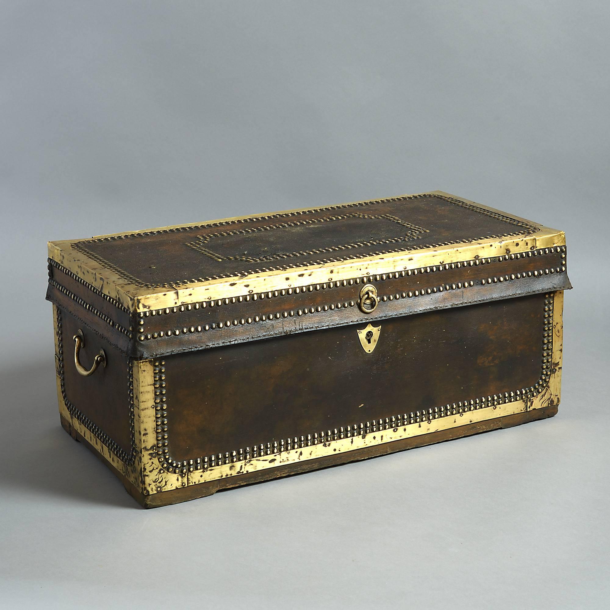 A good early 19th century leather travelling trunk, with panelled brass studding and having two carrying handles, lined with camphor wood and retaining an early retailer's label for Charles Hawkins, 86, Strand, London.