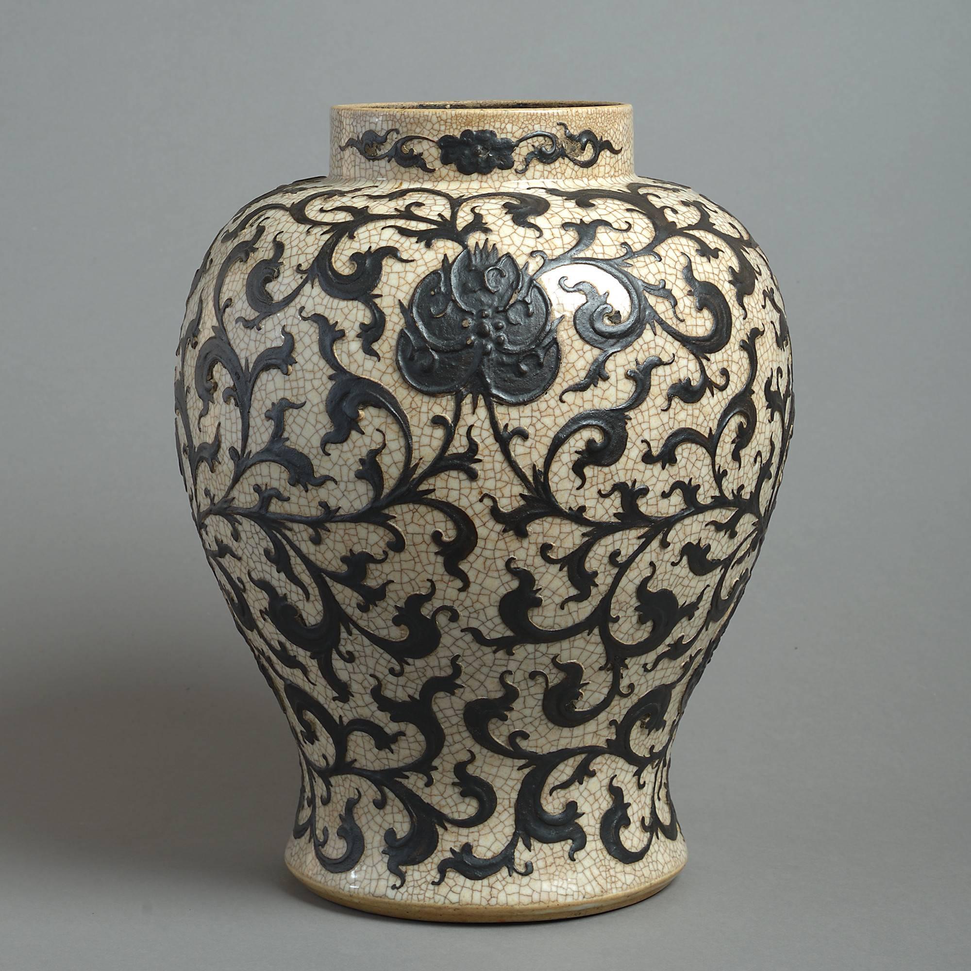 A late 19th century vase of baluster form with a cafe au lait crackle glaze and overlaid foliate decoration.