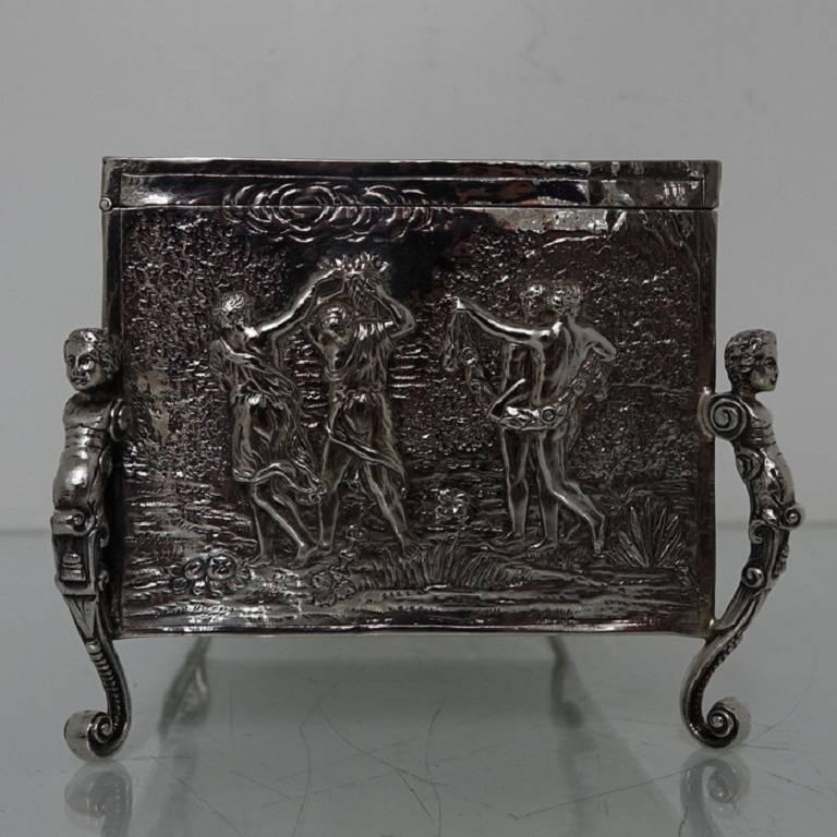 A very large continental silver jewelry casket with embossed scenes of cherubs, angels and chariots set amongst a rural background. The casket has four figural feet and the lid is hinged. 
The length is 23cm.