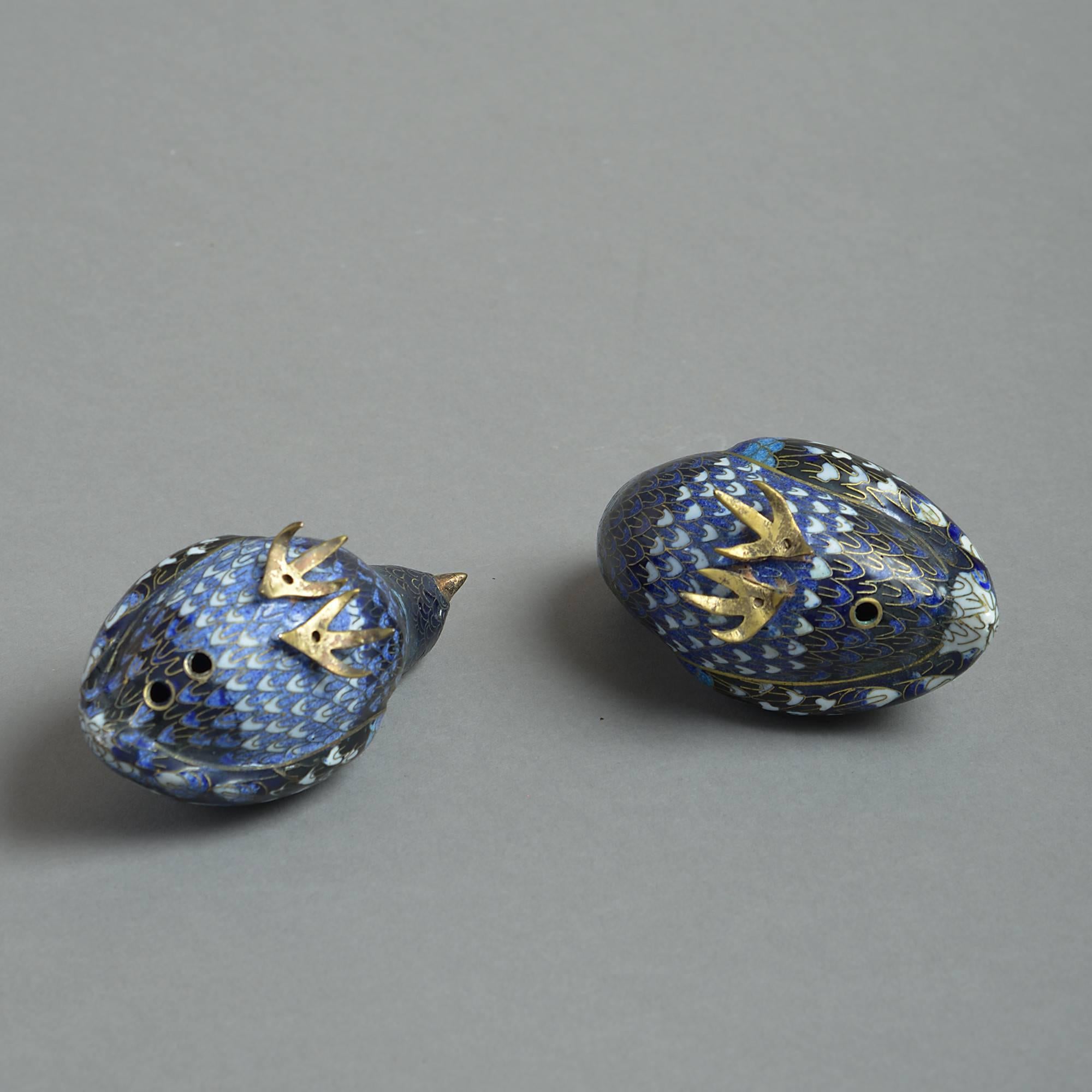 A pair of early 20th century Republic period cloisonné quail, modelled in the traditional manner and having blue, black and white enamels with brass beaks and feet.