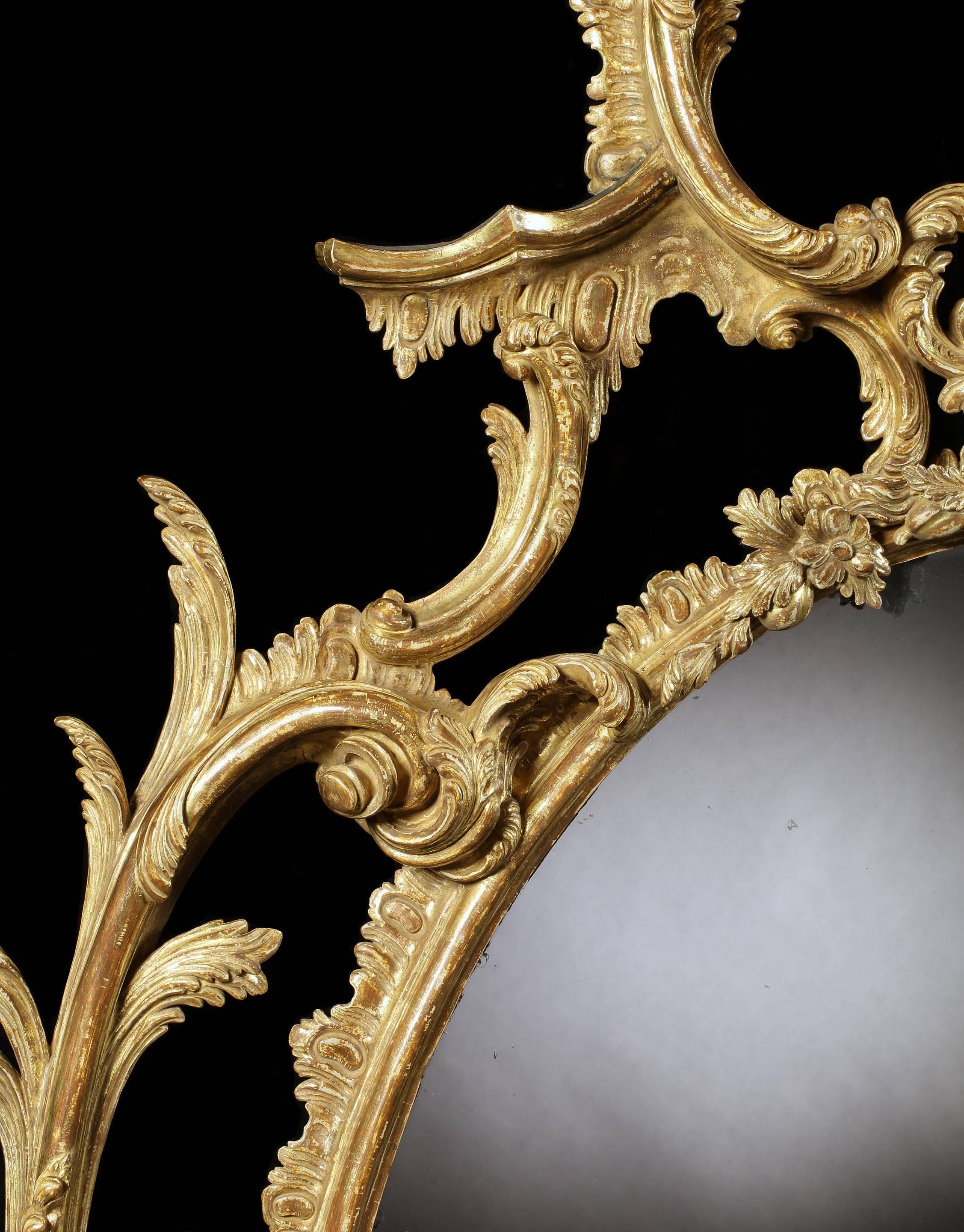 The mirror retains the original mirror plate, which was re-used from an earlier frame. The high cost of mirror plate in the 18th century meant that re-use was common practice at the time. 
The frame is re-gilded. 

The design for this finely