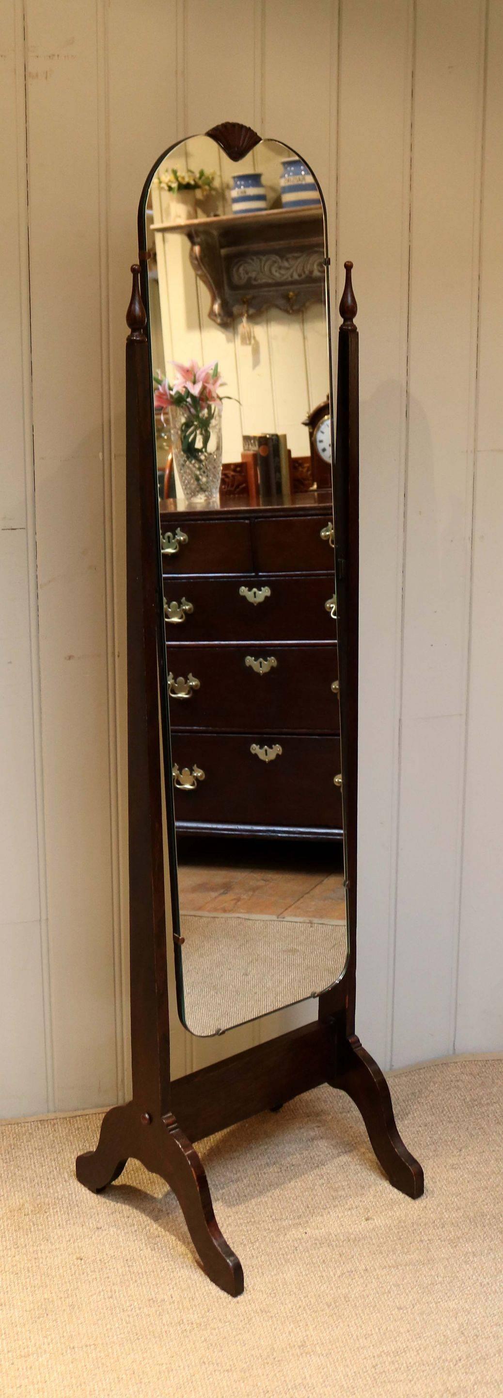 1920s cheval mirror with fan decoration set in an oak frame with outsplayed legs.