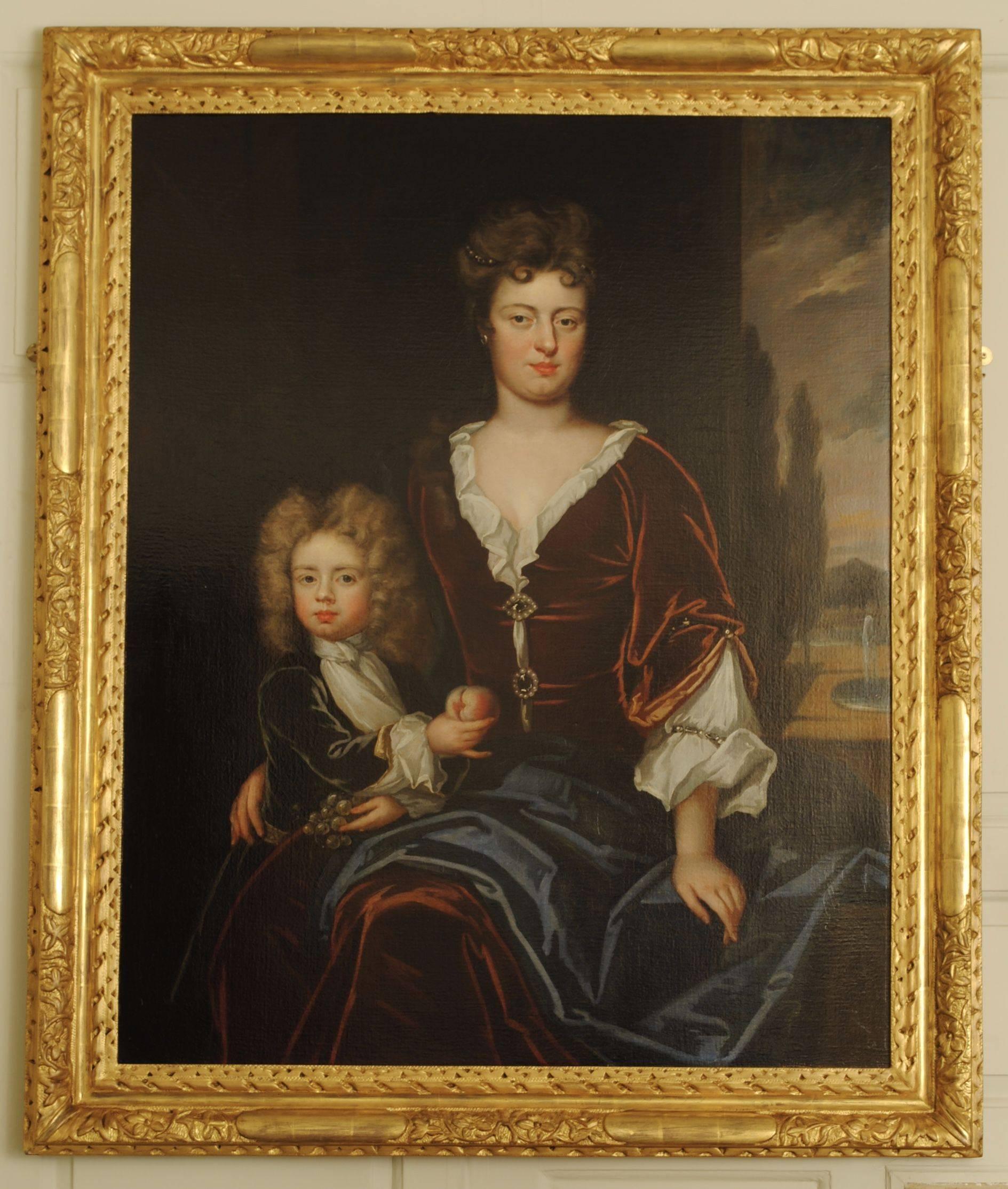 A fine pair of family portraits with husband, wife and child all painted in oil on canvas and in original giltwood frames.