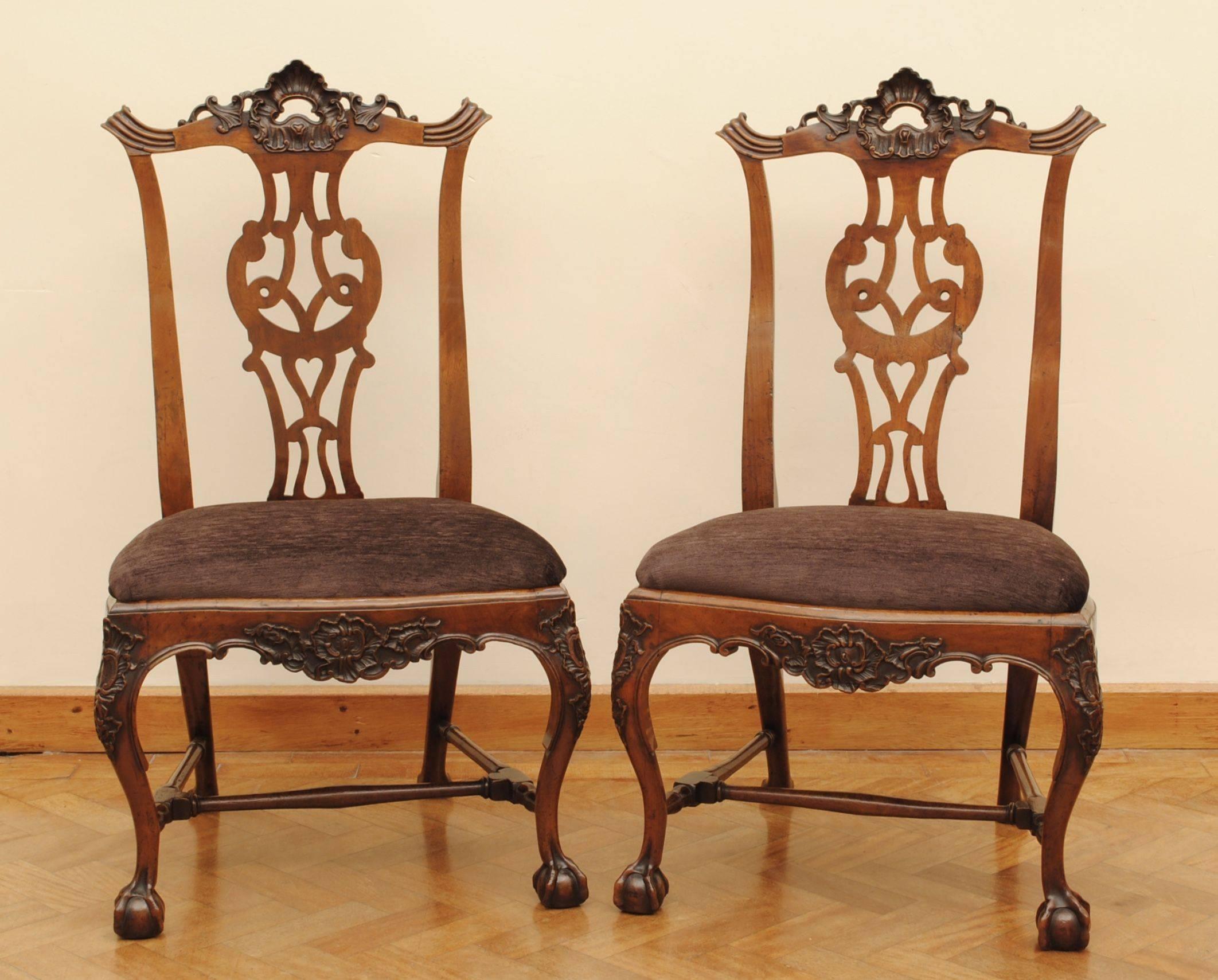 A set of eight carved walnut cabriole leg chairs with ball and claw feet and carved top rail. The style of these chairs show the influence of the Chippendale design book that made its way with the English merchants to Lisbon and was then used