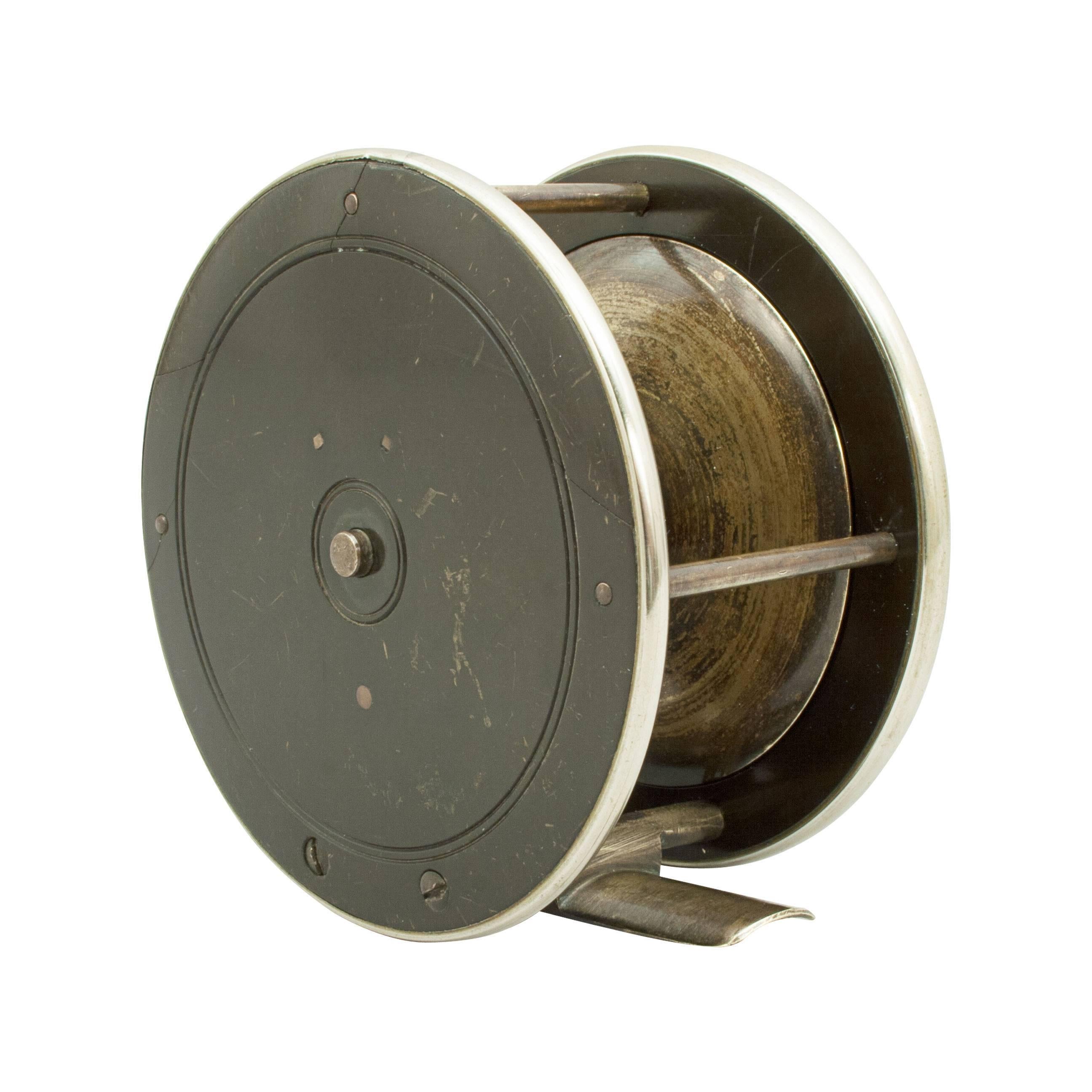 Brass sea trout fly fishing reel with check mechanism by Heabter, Plymouth. 
The reel stamped with the makers name on the face plate. The handle made from wood, probably walnut and the outer rims are nickel plate.